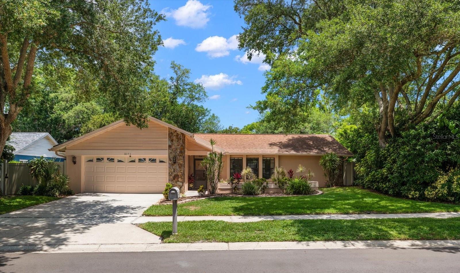 Welcome to this beautifully maintained 3-bedroom, 2-bath home in the desirable all-age Rustic Oaks community. Lovingly cared for by the current owners for over 35 years, this home sits on a beautifully landscaped quarter-acre lot with a private backyard and inviting pool area.Inside, you’ll find a spacious split floor plan featuring a living room, family room, dining room, and plenty of space for everyday living and entertaining. The interior was freshly painted in May 2026, while the exterior was professionally painted in 2025. Major updates include a roof installed in 2016, high-efficiency air conditioner with UV protection installed in 2017, hot water heater in 2024, water softener in 2022, Trane smart Wi-Fi thermostat, whole-house security system, and a new Orbit smart sprinkler Wi-Fi controller installed in 2025. The home also offers a hurricane-impact garage door, steel hurricane shutters, and a never-used Honda 7000is generator/inverter for added peace of mind. Step outside to your private backyard retreat featuring a sparkling pool with a premium Pebble Sheen Tec finish, solar pool heating and cooling system, salt generator chlorinator replaced in November 2023, pool pump replaced in 2024, and a pool screen enclosure completed in 2024. Located in a non-evacuation zone with no flood insurance required, this home offers convenience, comfort, and peace of mind. Just minutes from top-rated schools, shopping, dining, and stunning Gulf Coast beaches, with Tampa International Airport and St. Pete-Clearwater International Airport both approximately 30–35 minutes away.
