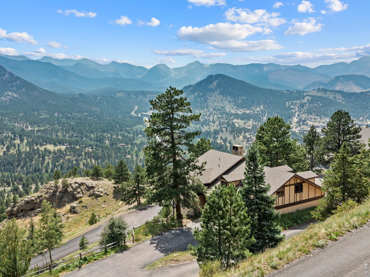 Unrivaled panoramic views of the Continental Divide take center stage from nearly every room of this beautifully updated mountain retreat. Perched high on Ram's Horn Mountain in the prestigious enclave of Windcliff Estates, this successful vacation home (with transferable STR license) offers nearly 1,900 square feet of comfortable living as one half of a duplex. More than $130,000 in recent improvements - including a stunning remodeled bathroom, professionally designed landscaping, flagstone patio, new driveway, roof, and outdoor living spaces - have elevated the property both inside and out. The inviting great room is centered around a gas fireplace, creating the perfect place to gather after a day of adventure. All three bedrooms walk out to beautifully landscaped flagstone patios, where breathtaking mountain vistas greet you each morning. Step outside with a cup of coffee, breathe in the crisp alpine air, and watch the sun rise over the Continental Divide. From your front door, hike directly to the summit of Ram's Horn Mountain or explore the endless trails and natural beauty of Rocky Mountain National Park just minutes away. Whether you're seeking an unforgettable mountain getaway, a place to gather with family and friends, or an exceptional investment opportunity, this is Colorado mountain living at its finest.