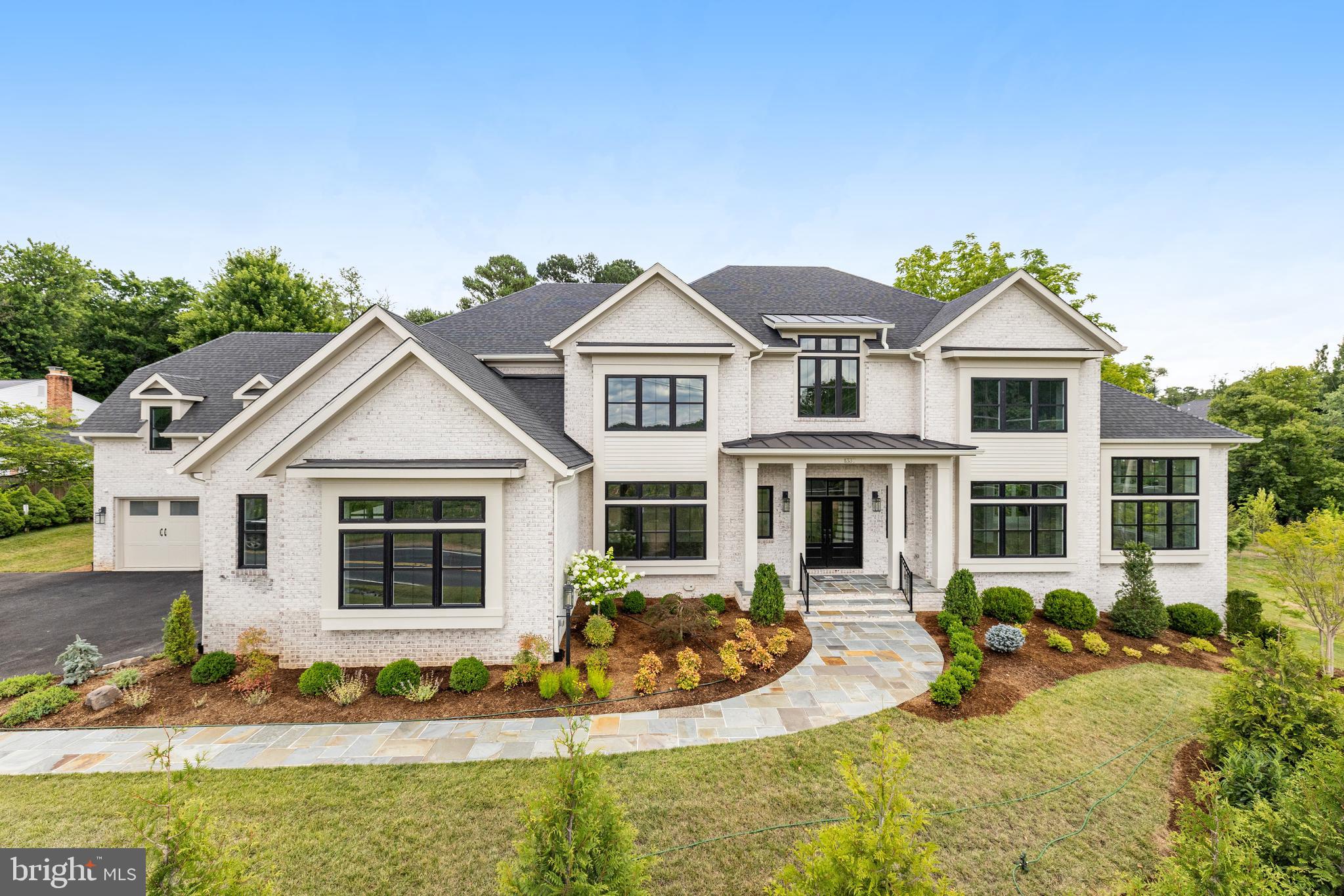 This EXPANDED Winthrop model features designer finishes and exceptional details consisting of 4-sides brick, oversized black windows and a 4 car garage.  A newly designed "clean contemporary" elevation and dramatic custom iron front entry door give this home unparalleled street presence.  Expansive kitchen with stacked designer inset cabinetry opens to the sunroom and family room featuring a 60" horizontal fireplace.  Additional rooms include formal living room, dining room, library and conservatory boasting cathedral ceilings.  The upper level provides 5 ensuite bedrooms including the spectacular owner's suite with separate sitting area, 2 huge walk-in closets.  The spa-like bathroom includes oversized frameless shower, free -standing soaking tub dual vanities and separate water closet.  A walkout lower level provides a theater/ media room, wet bar, casual living room, mirrored exercise room, and bedroom with dual entry full bath.  Additional features include 10ft ceilings on the main level with 9ft ceilings on the upper and lower levels, solid core doors throughout the home and expansive deck.  Available for Immediate delivery.