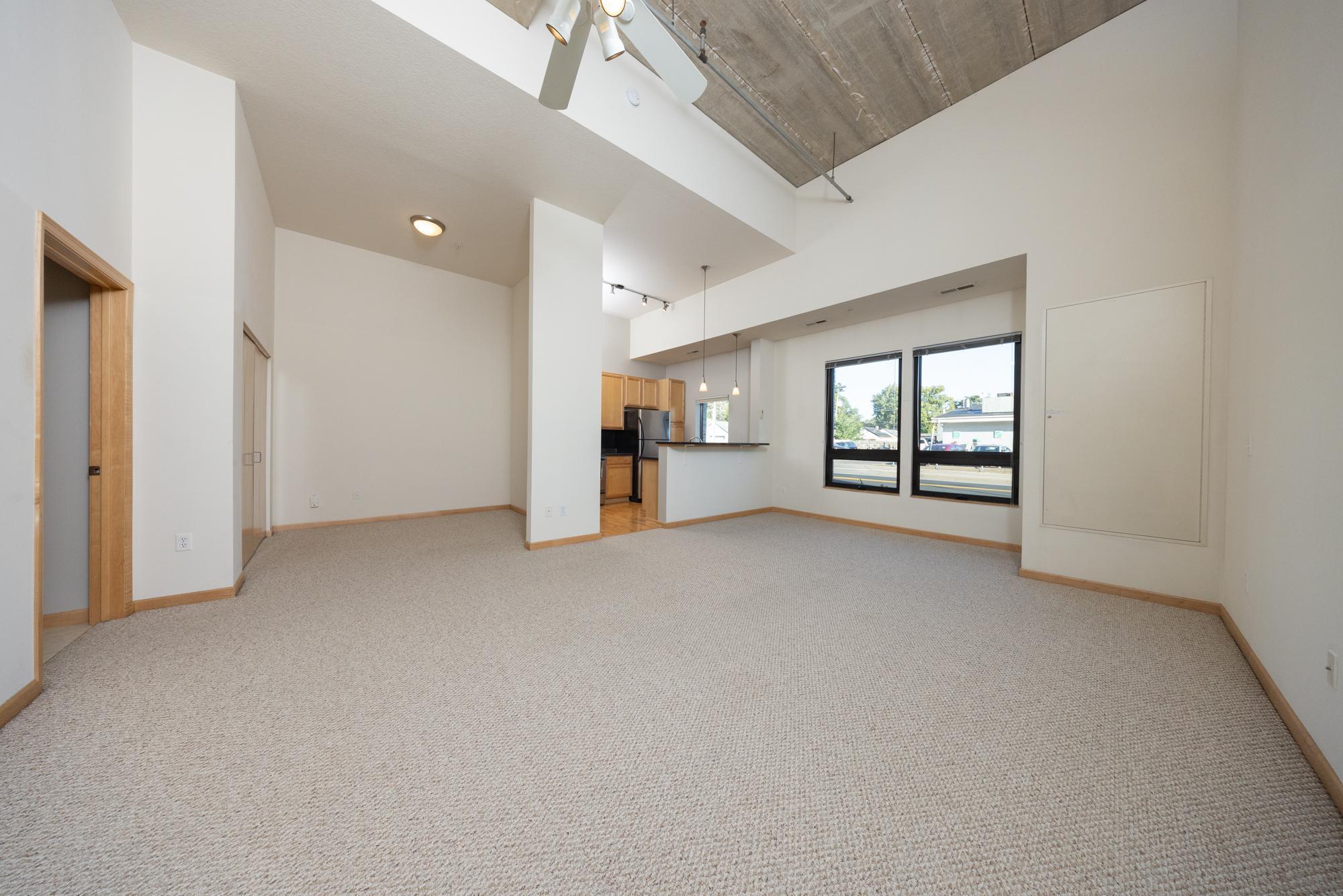 This beautiful condo is a standout with its soaring 16-foot ceilings and large windows that fill the home with natural light all day. This unit boasts one of the building’s top floor plans, a rare loft style design! The open layout and modern design create an inviting atmosphere.  Featuring an inviting kitchen peninsula that includes a breakfast bar. The oversized living room showcases wonderful views through the wall of windows. The spacious bedroom easily accommodates a king-sized bed and provides generous closet space. Additional highlights include in-unit laundry with washer and dryer, and a private storage locker close to the heated parking space. Building amenities include a community room, fitness center, car wash, convenient bike storage with direct outdoor access, and more! All this in a highly walkable location close to shops, restaurants, parks, and just a quick drive to the MOA and the airport.