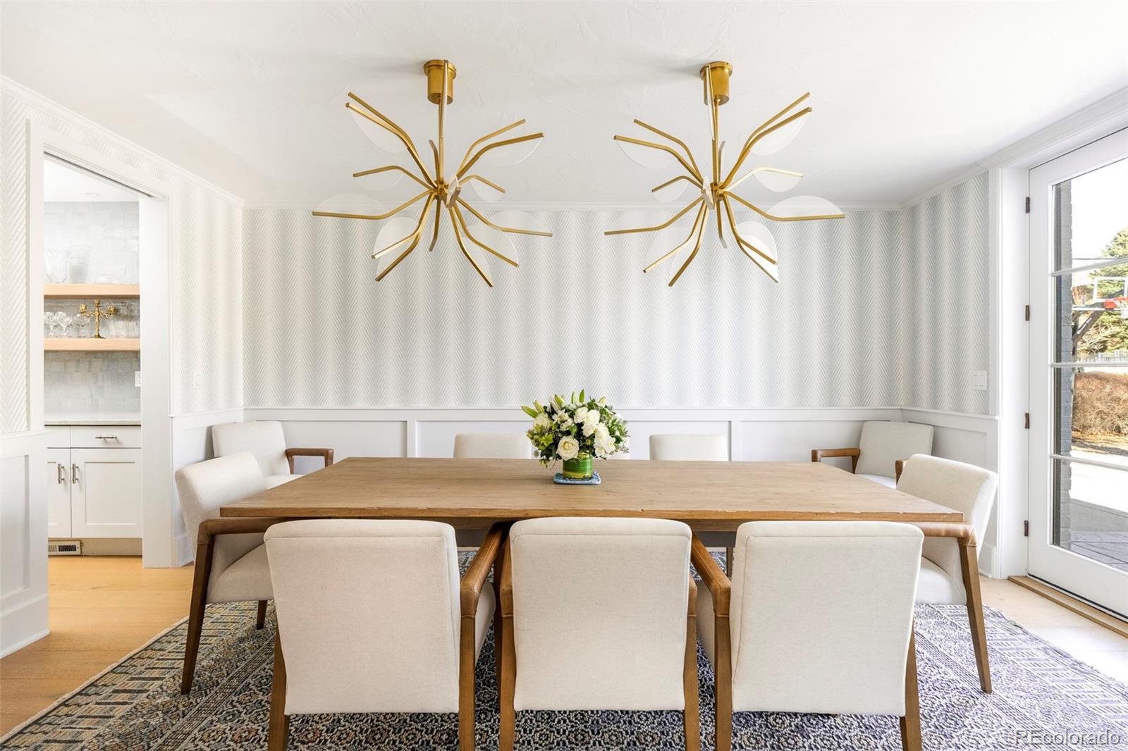 Welcome to this refined 5-bedroom, 5-bathroom Hilltop residence that gracefully blends timeless architecture with modern refinement, offering elevated Denver living in one of the city’s most sought-after neighborhoods. The light-filled main level unfolds in an open and thoughtfully designed layout, anchored by a spacious living room with coffered ceilings, custom built-ins, and glass French doors that enhance natural light and flow. The chef’s kitchen impresses with high-end appliances, a generous center island, and a welcoming breakfast nook, complemented by a butler’s pantry ideal for seamless entertaining. An elegant study featuring built-ins and a fireplace adds warmth, versatility, and functionality. The expansive primary suite serves as a private retreat, complete with its own balcony with mountain views and a luxurious five-piece bath. Additional bedrooms are well-appointed, offering comfort and flexibility, while a dedicated laundry room with dual washer and dryer sets provides exceptional everyday convenience. The finished basement extends the living space with a comfortable lounge, wet bar, custom wine room, and a guest bedroom with bath, perfect for hosting and relaxation. Outdoors, a private backyard oasis awaits with a patio and pergola designed for refined outdoor living. An attached three-car garage and a premier Hilltop location complete this sophisticated Denver home, offering enduring appeal, thoughtful design, and luxury living at its finest. Blocks to Cranmer Park, Robinson Park, Cherry Creek Mall and half a block to Graland Country Day School.