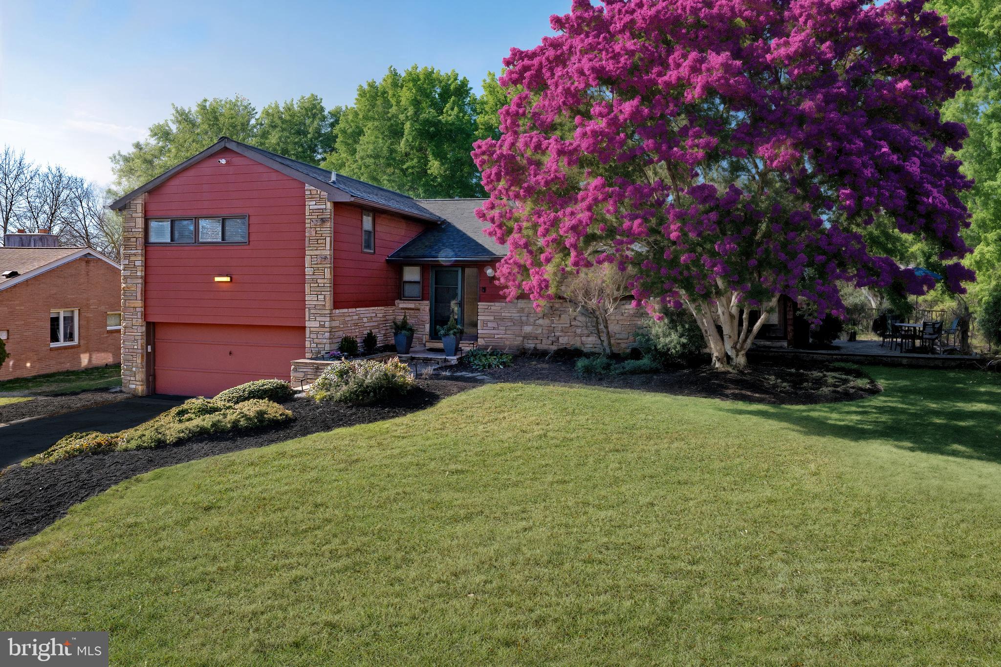 This impeccably updated mid-century split-level home offers a harmonious blend of timeless design and modern luxury with four bedrooms and two and a half bathrooms, spanning over 3,000 square feet of refined space.   Nestled on a serene cul-de-sac, it perfectly balances privacy and community, all while being moments away from the charm of Narberth and the convenience of Suburban Square.  The expanded first floor exudes a semi-open and airy floor plan, featuring refinished hardwood floors that flow through the formal living and dining rooms, a spacious den, and a stylish eat-in kitchen. Step outside to a newly refinished deck and pavers, overlooking a private, fenced backyard framed by mature arborvitae and vibrant annual plantings—an idyllic setting for outdoor entertaining.The second floor is a cozy sanctuary of comfort, highlighted by a luxurious primary bedroom with a fully renovated en-suite bathroom featuring radiant heated floors, custom vanity by Village Handcrafted,  Brizo fixtures, and a curb-less glass-enclosed shower. Three additional bedrooms, each with built-in closets, and a beautifully renovated hall bath with a convenient laundry chute complete this level.The walk out lower level offers a second den with mid-century built-ins, two-car garage with ample storage, and a sizable laundry room with backyard access to a fully fenced in backyard by Everlasting Fence.  Need extra space? The expansive basement features high ceilings, new LVT flooring, and endless possibilities with not only ample storage, but possibilities for a home gym, office, or rec room with an additional 900 square feet.  Notable upgrades include a 2020 roof by Rutter Roofing, a whole-house generator, and a Culligan water softening system among many other upgrades.   This is elevated living at its finest, along with the ease of public transportation within minutes of multiple Septa train stations.