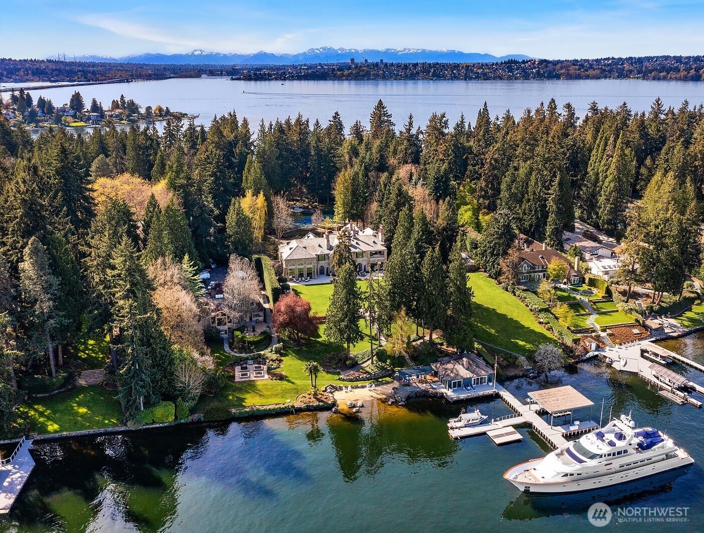 This unrivaled 4.3-acre legacy estate on Lake Washington resides in one the most sought-after waterfront communities in the world. Commanding 327 ft of shoreline, a remarkable dock is ready for your waterfront passions; boats, seaplane, jet skis & a yacht of 150+ ft are accommodated. Summers are spent at the beach, on the grand lawn, by the pool, playing tennis or strolling the gardens. Designed by Richard Landry, the finely crafted sandstone mansion is ideal for serene everyday living & spectacular entertaining. Floor-to ceiling black steel windows reveal the sparkling lake & lush grounds & fill the interiors with natural light. With an in-home gym, cabana, beach house/guest cottage & staff house, every need is met. Only on Hunts Point.
