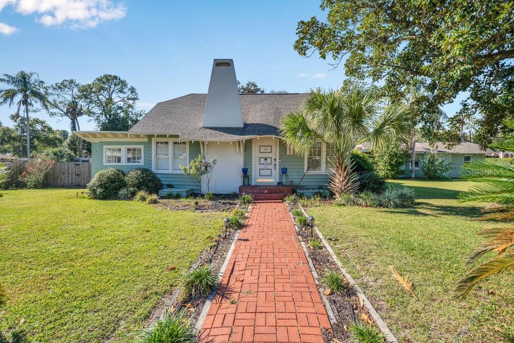 Sanford is proud to present this truly unique historic home, built in 1938 and full of character, sitting on a TRIPLE LOT. This spacious property offers a 5-bedroom, 4-bathroom split floor plan along with a separate 1-bed/1-bath in-law suite—perfect for supplemental income, guests, or multi-generational living.Inside, you’ll find charming surprises throughout. The generous primary bedroom features a beautifully renovated bathroom and a private entrance leading to a secluded deck. Upstairs, a large flexible space includes built-in storage and slide-out trundle beds, with plenty of room to convert into additional bedrooms if desired. The recently renovated galley kitchen is a chef’s delight, offering soft-close cabinetry with clever storage solutions, instant hot water, and a walk-in pantry.But the true showstopper is the backyard—an entertainer’s paradise. Enjoy the expansive, newly refinished 11-foot-deep pool with sun shelf, a tiki bar, beach area, koi pond, and a built-in brick fireplace. There’s also ample yard space for play, pets, or gardening, or if nature isn't your thing, it can be split and built on (price increase to now include this lot).  Oversized two car garage, TONS of extra parking for all your toys plus extra storage shed.Located in the historic Rose Court neighborhood, this home sits on a picturesque divided street with a park-like promenade running through the center. Situated within downtown Sanford’s golf cart district, you’re just minutes from the shops, restaurants, and lively events that make Sanford such a beloved destination.Don't miss the opportunity to experience this rare property—schedule your showing today! **PRICE ADJUSTMENTS REFLECTS ADDITION OF .2 ACRE PARCEL FOR A TOTAL OF .71