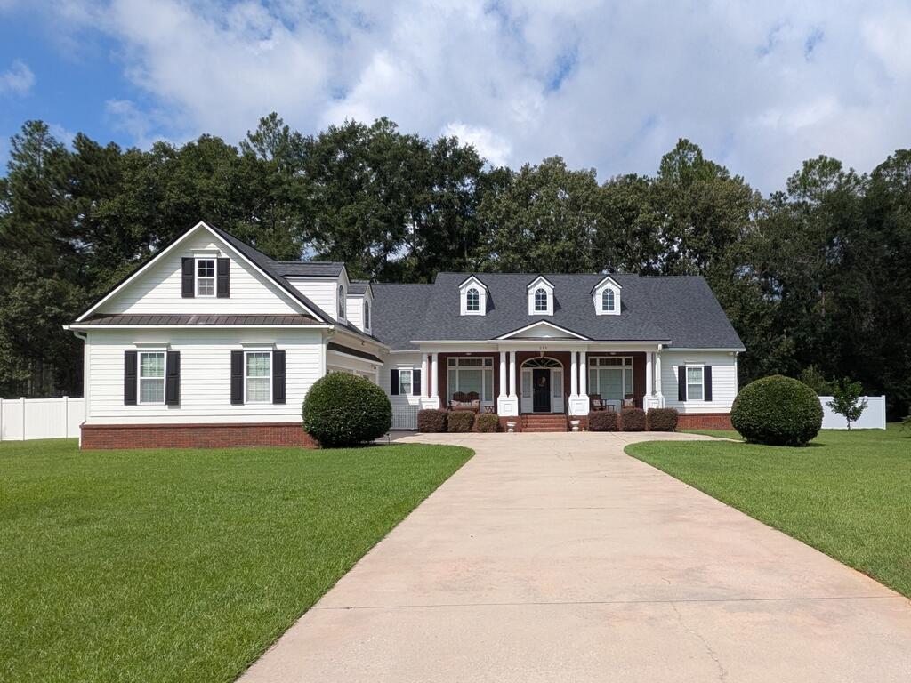 Located on the sought-after south side of Thomasville, you're just 30 minutes from the Tallahassee Trader Joe's and only 9 minutes from shopping and dining on the bricks in downtown Thomasville. This beautifully designed 4-bedroom, 3.5-bath home is the key to living a life of luxury with gorgeous wood floors, ornate coffered ceilings, wainscotting, and big windows that bring in plenty of natural light. The vaulted living room with fireplace offers a warm, inviting feel, and the kitchen features lots of counterspace, double islands, stainless steel appliances, tons of cabinets, and under-cabinet lighting. The spacious primary suite includes a sitting area and a trey ceiling. The primary ensuite bathroom showcases a walk-in closet, a ceramic tile garden tub, separate shower, large dual vanities, and a beautiful vaulted ceiling with a chandelier. A second big bedroom with an ensuite bathroom provides the perfect place to house family, friends, and guests of all kinds. On the other side of the house, another two bedrooms are located which are connected to each other through a lovely Jack-and-Jill bathroom. A spacious laundry room with a sink, pantry and 2-car garage also provide tons of storage space. as well as a  heated and cooled bonus storage area just inside the garage that can be utilized for any number of things.  Outside, the large front porch and spacious back deck provide the perfect place to host friends and family or to unwind after a long day. Schedule your private tour today!