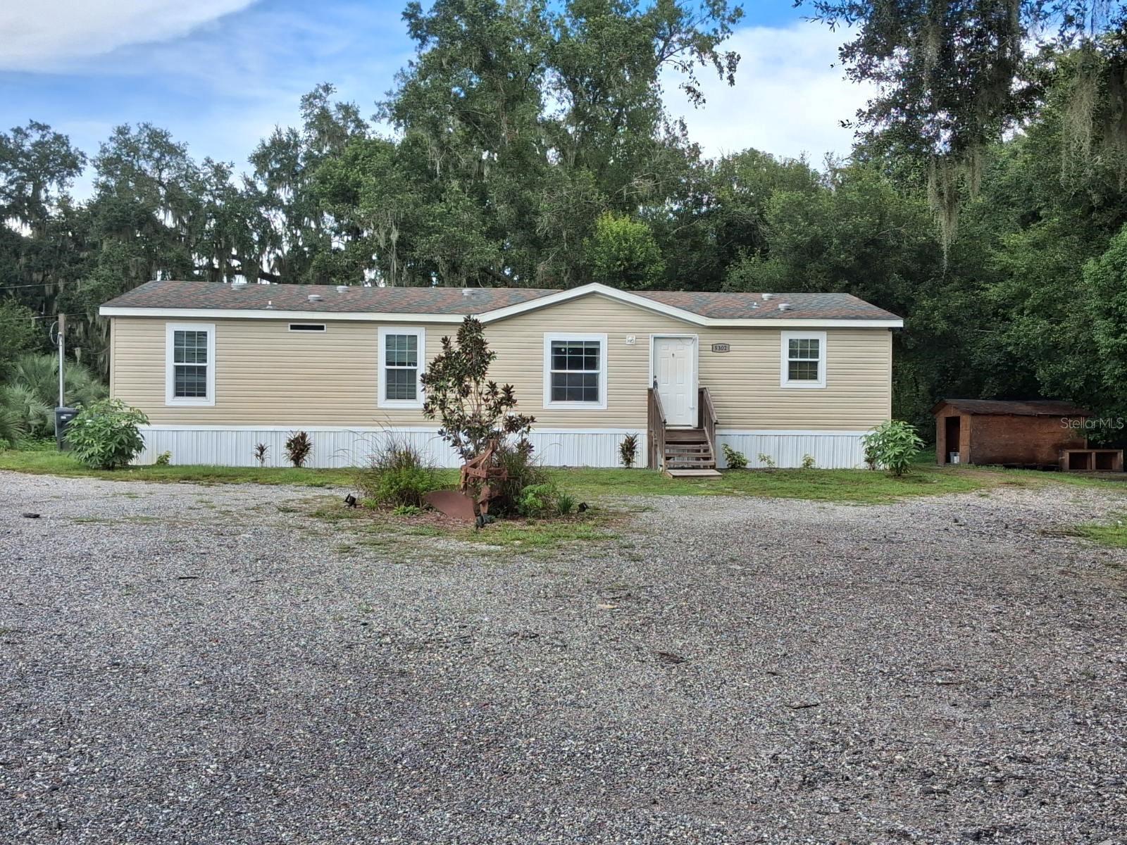 Fantastic opportunity to purchase a double-wide home on 2.56 acres of land! Looking for privacy on an acreage lot, yet just a 10-min drive to highway access, schools, shopping and restaurants? This gem offers so many great features at a fantastic price!! This property was a model home in 2024, so all well/septic and HVAC are only two years old. The builder placed the home in an elevated location with extra driveway space and turn-around. The home has upgraded luxury vinyl flooring throughout, a gorgeous built-in electric fireplace, can lights, drywall & textured walls and ceilings, and features an open floor plan. The living room sliders lead out to a large, covered deck. The kitchen has a huge center island, an enormous walk-in pantry, lots of cabinets and counters too. There is also a separate laundry room. The primary bedroom features a large walk-in closet, wonderful en suite bath with double sinks, soaking tub and separate step-in shower. There is currently a small tree farm located on the property, which the new owners can leave in place for application to reduce taxes, or sell the trees and apply the profits as desired. The newer well also has a quality water softener / filtration system. This property is perfect for someone looking for an affordable home in an amazing location with plenty of privacy yet neighbors are relatively nearby.  This property will qualify for FHA/VA or USDA zero-down loan.  Come see all this wonderful opportunity has in store today!
