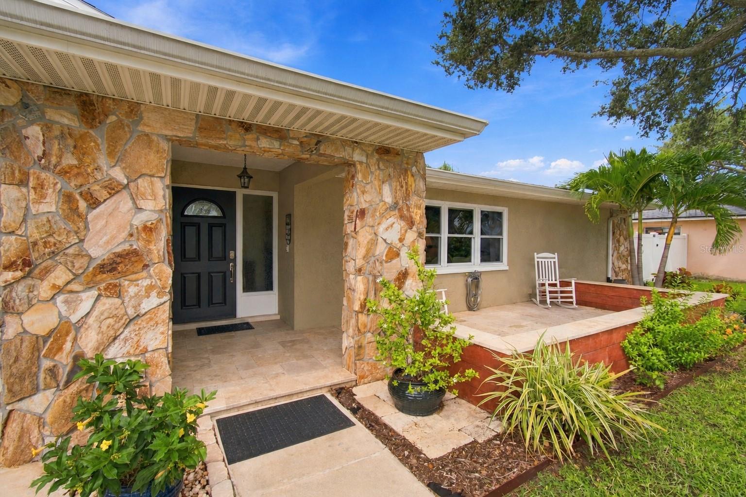 What if home felt like an endless Florida getaway? Nestled near Eagle Lake Park with no HOA in an established Largo neighborhood, this split plan 4-bedroom, 2-bath pool home offers 2,178 square feet of thoughtfully designed living space, custom craftsmanship, and a backyard made for enjoying the Florida lifestyle.At the heart of the home, solid cherry custom cabinetry brings warmth and character to a spacious kitchen featuring a large center island and premium KitchenAid appliances including built-in oven and convection microwave making entertaining and family meals a breeze.  Counter-depth refrigeration, extended island seating, and a dedicated beverage center give you space for everyone. Solar tubes bring natural light into the living spaces, creating a bright and welcoming feel throughout the home. The split-bedroom floor plan offers flexibility for family, overnight guests, a home office, or hobbies, while the private primary suite features a custom walk-in closet and thoughtfully designed shower.Step outside and you'll discover two distinct spaces for enjoying Florida living. The screened-in lanai creates an outdoor room of its own, with plenty of space to relax, dine, entertain, or simply enjoy your morning coffee. Overhead solar screening helps provide shade, while fine-mesh No-See-Um screening along the sides lets you enjoy the fresh air with added comfort.Just beyond the lanai, the saltwater pool feels like its own private backyard retreat. A durable PebbleTec finish, updated saltwater equipment, and surrounded by pavers creates an inviting place to swim, lounge, and spend sunny Florida afternoons. Surrounding it all is a fully fenced backyard dotted with mature mango, Meyer lemon, fig, peach, tangelo, and tangerine trees. Pick fresh citrus from your own yard, take a dip in the pool, then settle into the lanai for dinner. Here, the backyard truly becomes an extension of the home.And while the Florida lifestyle may draw you in, the recent improvements provide plenty of reassurance such as newer vinyl insulated glass windows, patio sliders, and outswing steel doors. The roof was replaced in 2023, the vinyl privacy fence and water heater in 2022, saltwater pool equipment and porch screening in 2024, along with the A/C coil and whole-house water filtration system in 2025.An oversized garage with built-in shelving, central vacuum system, dual sump-pump drainage system, and custom garden shed add even more function. With four flexible bedrooms, a private pool, an established neighborhood, no HOA, and many of the major projects already addressed, this is a home designed for you if you would rather start enjoying Florida living than start working through a renovation list.Come see what happens when the house, the backyard, and the Florida lifestyle all come together.