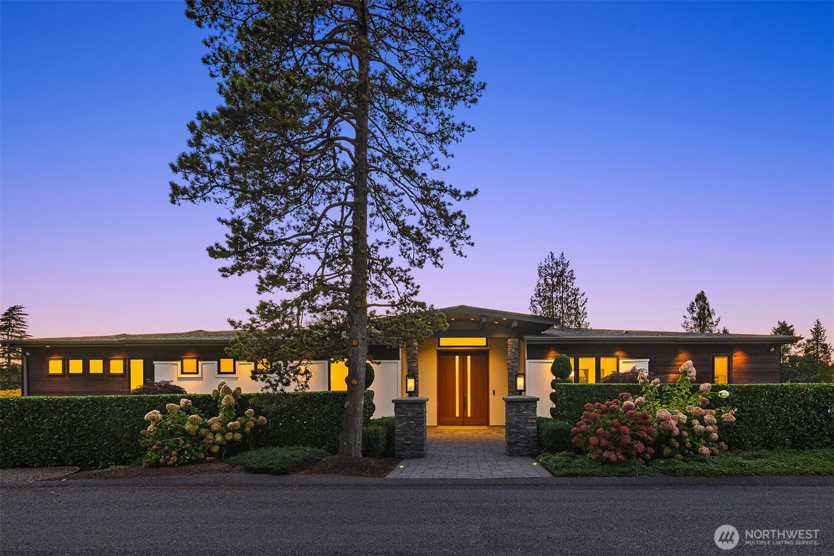 Exceptional custom luxury in the heart of Yarrow Point, this Wayne Dake–built residence offers sweeping views from the rooftop deck and main living areas, enhancing the sense of scale and serenity. This 6,019 sq ft home sits on a 0.347-acre landscaped lot and has undergone a meticulously executed two-million-dollar enhancement, elevating its craftsmanship, technology, and overall living experience. The property offers 5 bedrooms and 5.5 baths with extensive high-end upgrades throughout. Highlights include a spa-like primary suite with heated floors, curated Ann Sacks tilework, custom marble, fully remodeled baths with steam shower, an Ortal fireplace, hardwood floors, and bespoke built-ins. Modern systems include near net-zero solar with battery backup, micro-split climate control in every room, whole-house audio, a media room with 4K projector, enterprise-level networking, and comprehensive security. Smart lighting, an EV charger, a wine room, and lush grounds complete this exceptional offering. A rare opportunity to experience refined luxury living mere minutes from Bellevue, with effortless access to Seattle’s urban conveniences.