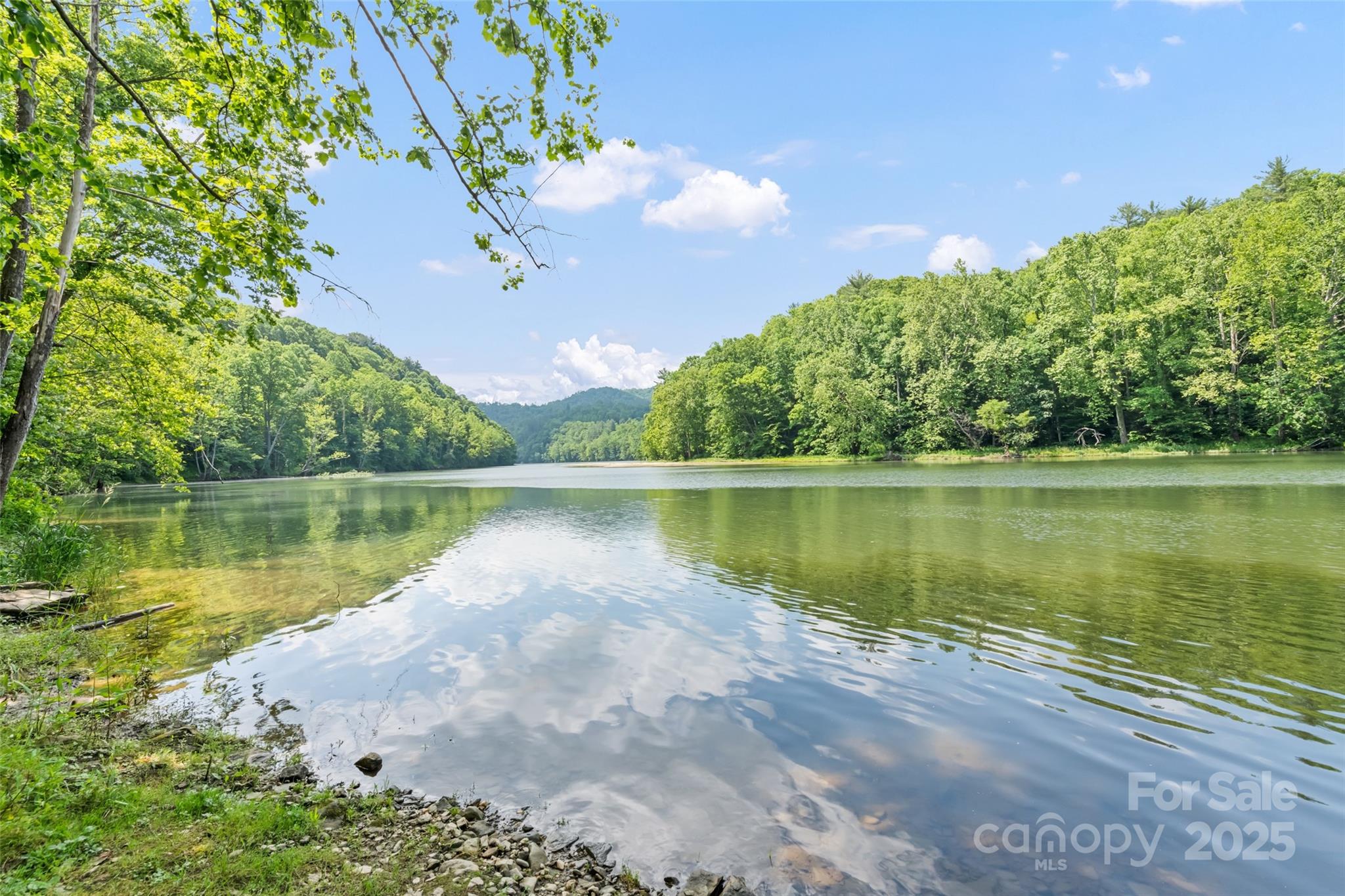 Discover a rare opportunity to own ±74 acres of picturesque land on the scenic shores of Waterville Lake. With approximately 2,000 feet of pristine shoreline and a gentle-grade boat launch, this property is perfectly suited for lakeside living and endless outdoor adventures. A historic late-1800s farmhouse still stands on the land, echoing the timeless character of this special place. Whether you dream of building a private estate, developing multiple home sites, or creating a campground with trails and fishing, this land offers endless possibilities. Enjoy rolling woods, mountain and lake views, abundant wildlife, and peaceful seclusion just five minutes from I-40. Hike, fish, paddle, or simply soak in the beauty of your own waterfront sanctuary. This is a haven for nature lovers, investors, and anyone seeking privacy and potential on the lake. Don’t miss this chance to create your vision in the heart of Western North Carolina!