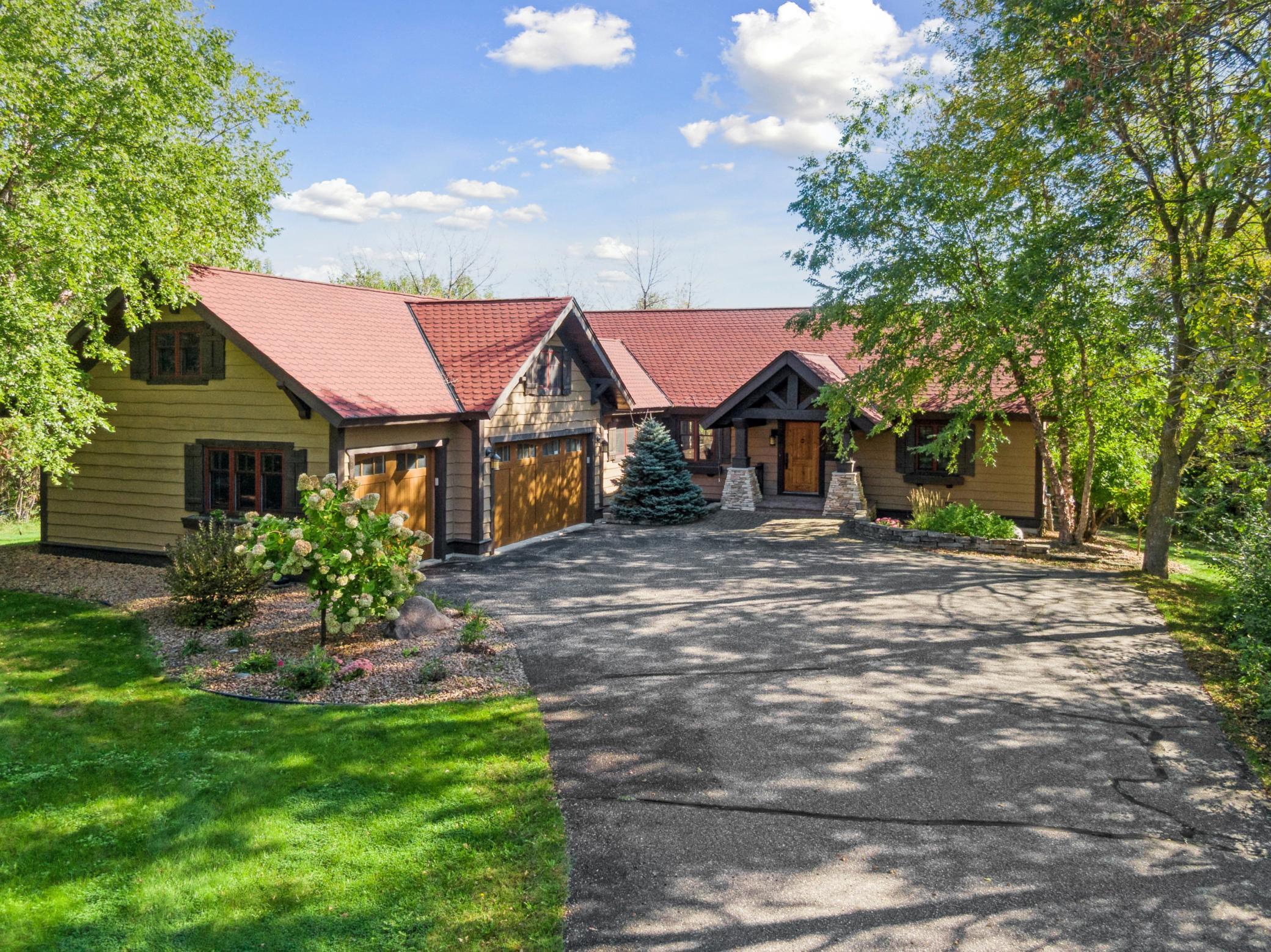 Located on 2.5 private acres with 220 feet of prime West Lake Sylvia shoreline. Fully furnished property combines warm lodge-style character with modern luxury and convenience. Soaring vaulted ceilings and rich natural woodwork create a grand yet inviting atmosphere. Floor-to-ceiling windows showcase panoramic lake views and fill the open-concept living spaces with natural light. Upper-level loft is a dedicated retreat with custom built-in beds and a hangout space. Walkout lower level features cozy fireplace and extensive custom built-ins. Lower level includes two bedrooms plus a flexible nonconforming bedroom ideal for home gym, hobby room, or overflow guest space. Off the main level, a two-season porch with vaulted ceilings overlooks the lake and offers a peaceful place for morning coffee or evening relaxation. From the porch, step out to an oversized deck perfect for entertaining, grilling, and enjoying the stunning morning sunrise. Exterior features include custom firepit area, gentle walking path to expansive brick patio for lakeside lounging and gatherings, and a pristine sandy beach with water clarity depths typically reaching 10–15 feet. This makes it a top-tier destination for swimming and diverse water sports. With two private docks, there is ample space for all your watercraft, while a convenient grandfathered-in boat house provides tidy storage for toys and gear. Rare offering that delivers privacy, comfort, and effortless waterfront living in a desirable private and peaceful location on West Lake Sylvia!