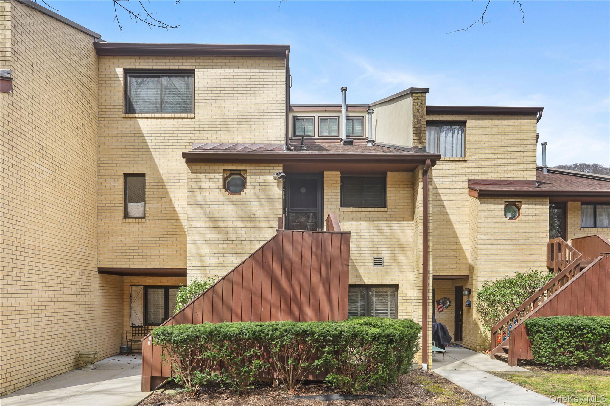 Welcome to Chestnut Oaks, a sought-after condominium community just moments from downtown Chappaqua. This sun-filled 1-bedroom plus loft and den residence offers 5 well-designed rooms, 1.1 updated baths, and a flexible layout ideal for today’s living. The inviting entry hall features tile flooring and a generous closet, leading to an updated powder room accented by a charming octagonal window and Carrera marble floor. The renovated kitchen showcases stainless steel appliances, crisp white cabinetry, black granite countertops, and a Carrera marble subway tile backsplash, with a convenient pass-through to the dining area. The expansive living/dining room is highlighted by laminate wood flooring, recessed lighting, oversized windows, and a dramatic partial cathedral ceiling—perfect for entertaining or relaxing. Upstairs, the spacious primary bedroom includes wall-to-wall carpeting, recessed lighting, crown molding, and two double closets. An updated dual entry bath, from the hallway and primary bedroom, features gray tile flooring and a white tile tub surround. The open loft, with sliding glass doors to a private balcony, provides an ideal home office or reading nook. Additional features include a versatile den or guest space with crown molding and clerestory windows, and a convenient laundry closet with stackable washer and dryer. Enjoy complex amenities including an outdoor pool and tennis court. Ideally located close to shops, restaurants, library, park, farmer’s market, and train to NYC, this residence offers comfort, convenience, and a true Chappaqua lifestyle.