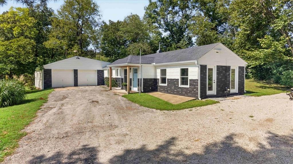 SELLER-OFFERED 3-2-1 TEMPORARY MORTGAGE BUYDOWN with an acceptable offer! Subject to buyer qualification, lender approval, loan-program limits and final contract terms. Confirm current loan terms and exact buydown funding with your lender. Acreage + private dock: start lake life with lower initial mortgage payments! Enjoy this renovated 3-bedroom, 3-bath ranch on a private 0.59-acre lot at Lake Lotawana, complete with a private dock remodeled with all-new decking. Spend your days boating, fishing, swimming or kayaking, then return home to comfortable one-level living and room to unwind outdoors. The dock is accessed through a nearby public easement; see the dock-access map in the listing photos.The renovated kitchen features new cabinetry with under-cabinet lighting, stainless steel appliances, a separate coffee bar and an impressive 8' x 4' walk-in pantry. Wood-plank flooring connects the inviting living spaces. The primary suite offers new carpet, a walk-in closet and an updated bath with a double vanity and glass-enclosed shower with dual shower heads. An outdoor shower just off the suite makes cleanup easy after a day on the lake. Two additional bedrooms and beautifully tiled bathrooms complete the layout.Extensive improvements include new siding and exterior doors, select new windows, updated electrical wiring and panel, and new HVAC. An attached 2-car garage adds everyday convenience. Make this your full-time home or weekend retreat, with access to Lee’s Summit shopping, dining and everyday amenities.Dock directions: Turn right from the driveway and continue approximately three houses to the vacant lot on the left. Follow the public easement to the water, then turn right to the remodeled dock.Temporary buydown payments increase annually during the first three years; the full note-rate payment begins in year four.