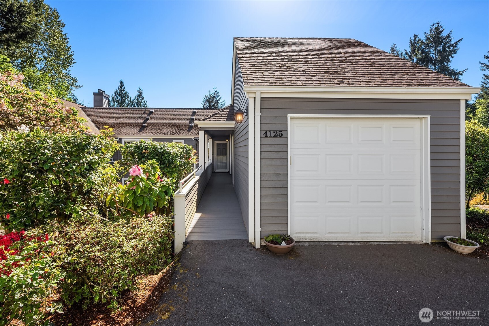 Providence Point is a highly desirable 55+ active community set on 161 acres of beautifully maintained grounds.This no stairs condominium is ideally positioned above the trees, offering excellent privacy, abundant natural light, and a peaceful setting. The home features spacious rooms, generous storage throughout, fresh paint, and new floor coverings. Enjoy a cozy wood burning fireplace, central forced air heat and air conditioning, and a spacious balcony ideal for relaxing or entertaining. The kitchen is loaded with cabinetry and finished with granite countertops. Both bathrooms have been recently updated, including a primary bath with a large walk in shower. A spacious garage provides additional storage and workspace for hobbies. Community amenities include professional landscaping, exterior maintenance, 24/7 safety services, water, sewer, basic cable and internet, indoor pool and spa, fitness center, walking trails, tennis and pickleball courts, library, classes, event spaces, on-site management, activities coordinator, and shuttle service to local shopping.