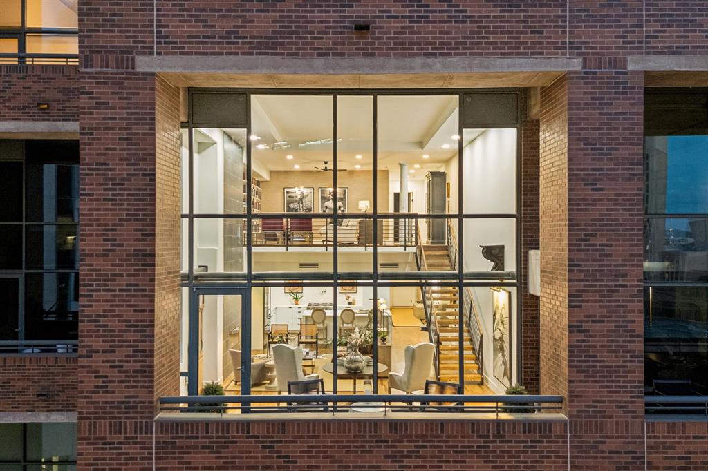 Experience elevated loft living in this extraordinary architecturally reimagined loft residence at 1999 McKinney, where sophisticated design meets effortless luxury. Following an extensive eight-month renovation, this exceptional home was meticulously reimagined with an uncompromising commitment to craftsmanship, refined finishes, and intelligent design.Created to maximize openness, storage, and functionality, the residence blends modern elegance with timeless style. Custom millwork, suspended drywall ceilings, designer finishes, and Lutron lighting create a warm, gallery-inspired ambiance.The chef's kitchen was rebuilt from the original sheetrock and features a dramatic quartz waterfall island, custom cabinetry, a sculptural range hood, professional-grade appliances, a pot filler, built-in wine refrigerator, and a custom dry bar—perfect for entertaining.The dramatic living room showcases soaring ceilings, an expansive wall of glass, captivating city views, and an elegant fireplace framed by a striking two-story tile feature. Programmable accent lighting creates the perfect setting for displaying artwork.The primary suite, a luxury private retreat, features a spa-inspired bath, a custom walk-in closet, and an additional secondary closet.Every bathroom, floor, ceiling, lighting fixture, closet, and designer finish was thoughtfully selected to create a cohesive, turnkey residence.The floor plan offers 2 bedrooms, a dedicated office, 2 living areas, 2 private balconies, and 2 oversized storage units.Perfectly positioned in the heart of Uptown, residents enjoy exceptional walkability to premier restaurants, cafés, luxury boutiques, grocery stores, Klyde Warren Park, the Arts District, and world-class sports and entertainment venues. Amenities include a resort-style pool, outdoor grilling area, fitness center, and lock-and-leave living.A rare opportunity to own an impeccably renovated luxury residence in one of Uptown Dallas' most desirable addresses.