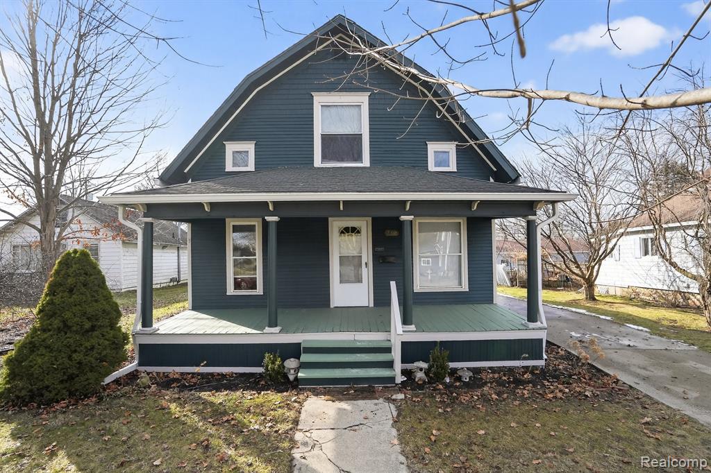This delightful four-bedroom residence showcases modern amenities while beautifully blending classic  features. Upon entering from the freshly painted exterior, you’ll be welcomed by original wood floors and a spacious front porch that creates a warm and inviting atmosphere. The kitchen has been revitalized with new flooring, featuring oak cabinets and plenty of counter space. Convenience is a priority, highlighted by a first-floor laundry room and a bedroom for easy accessibility. Upstairs, you'll discover generously sized bedrooms adorned with fresh carpeting. The home includes a high-efficiency furnace and air conditioning, ensuring comfort throughout the year. With just a ten-minute walk to downtown, this property perfectly combines charm and convenience.