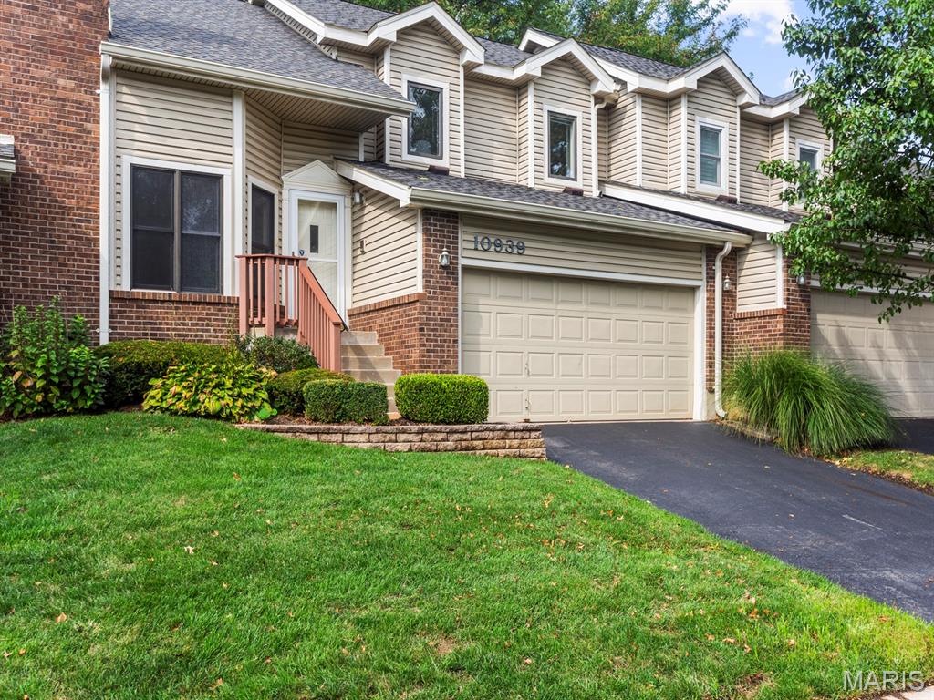 Welcome to 10939 Vauxhall Drive in the highly desirable Briarcliff Community, served by Ladue Schools! This move-in ready villa features a private driveway and attached 2-car garage. Step inside to a sun-lit living room featuring vaulted ceilings, built-in shelving, and a cozy woodburning fireplace. Down a few steps, the open-concept kitchen seamlessly connects to an oversized dining and family space with easy access to the guest bath, laundry room, garage, and backyard. Upstairs, the expansive primary suite offers two closets and an updated ensuite bath with a dual vanity and spacious shower. Two additional bedrooms—one featuring access to a private deck—and an updated hall bath complete the upper level. With fresh paint throughout, brand-new carpeting, and a newer air conditioner, this home is ready for you to move in!