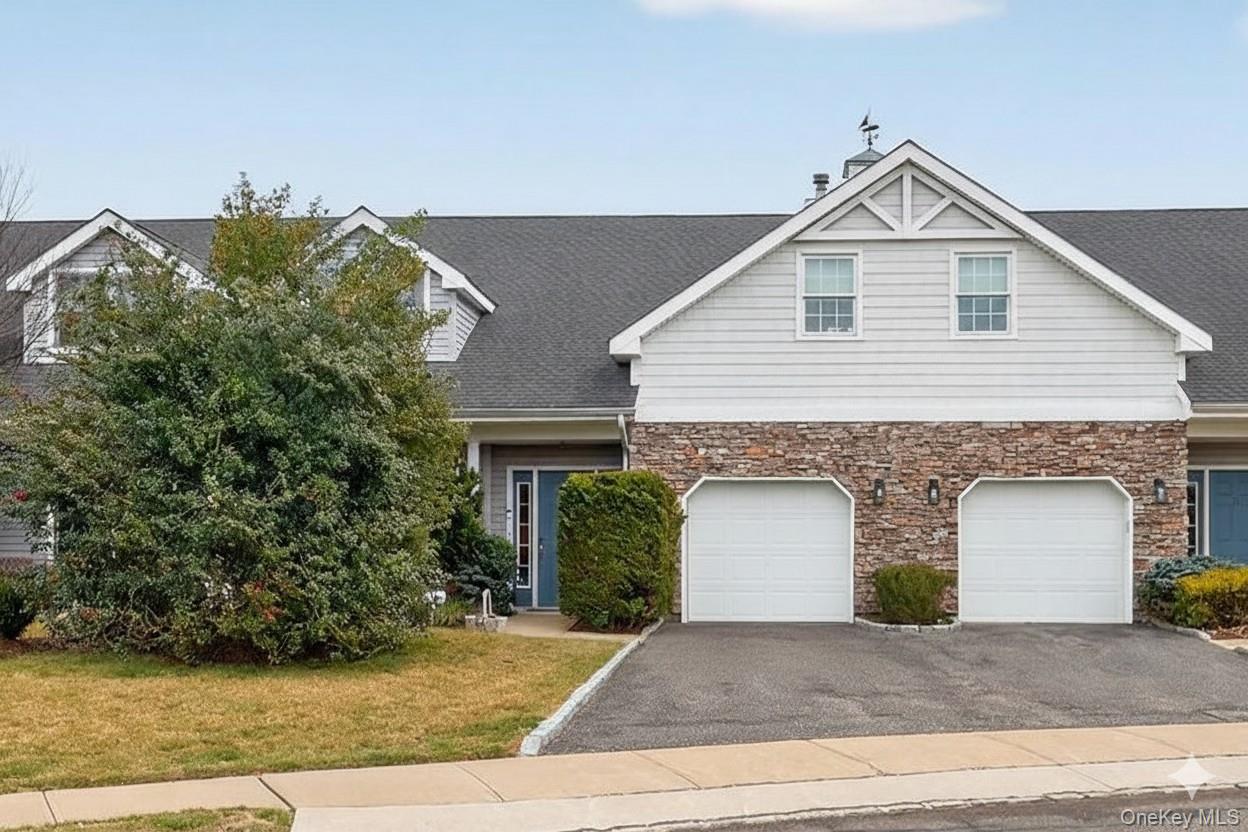 Welcome to refined, resort-style living in Mill Pond Acres, a prestigious 55+ gated community in the heart of Port Washington. This custom-model townhouse offers a thoughtfully designed layout with 4 bedrooms and 2.5 baths, blending comfort, flexibility, and elegant architectural details.The main level features a primary bedroom suite with a spacious dressing room, which can be a  fourth bedroom or home office, along with a powder room. An open-concept kitchen with center island flows seamlessly into the great room, highlighted by dramatic two-story ceilings and sliding doors to a private patio, perfect for indoor-outdoor entertaining.Upstairs, you’ll find two additional bedrooms, a full bath, and a large open loft that serves as an inviting den or lounge. This space is enhanced by a fireplace and a balcony overlooking the living room, creating a warm and airy atmosphere.Additional features include a one-car garage and access to Mill Pond Acres’ exceptional amenities: a clubhouse, indoor pool, fitness center, sauna, hot tub, tennis and pickleball courts, and multiple gazebo seating areas throughout the community. All of this is complemented by the highly regarded Port Washington School District.