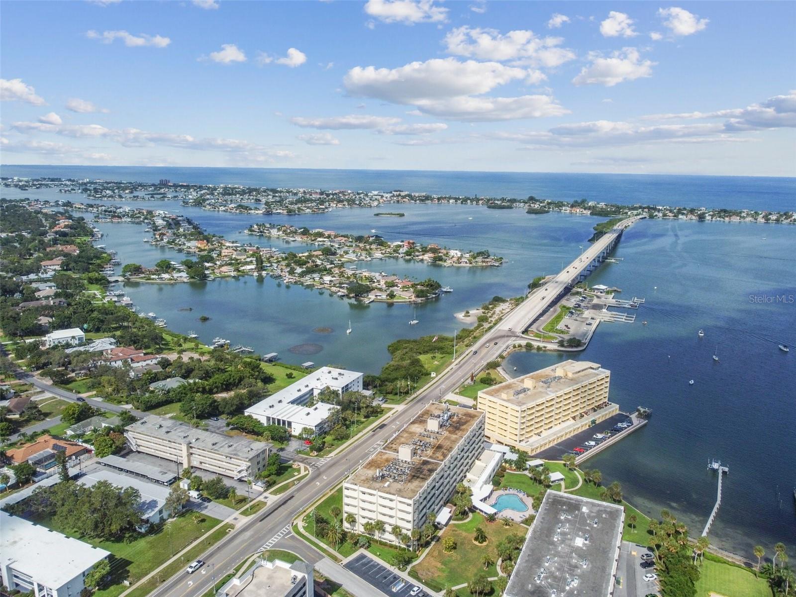 TURN-KEY MOVE-IN READY!!! Breathtaking views and stunning sunsets await you from this sixth-floor Penthouse condo, featuring a heated pool at the edge of Clearwater Bay, within the highly coveted Harbour Club Condominiums. Located at the corner of West Bay and Bluff View Drive in Belleair Bluffs, this exceptional unit is part of a well-built structure with a fully funded new roof and freshly painted exterior, completed in 2025.

This condo offers the comforts of home while providing the simplicity of a personal vacation oasis, as the meticulous owners use it as their occasional getaway. With elegant, low-maintenance Travertine flooring throughout the UPDATED living room, dining room, bedroom, den, kitchen, and both full baths, this cozy space boasts a neutral decor.

The den can serve multiple purposes: as a reading room with a stunning view, a HOME OFFICE, or a quickly convertible guest room. Additionally, the second bathroom is perfect for accommodating visitors or overnight guests. Convenience is key with an assigned parking space in the covered GARAGE, just steps from the elevator.

Awaken each morning after a restful night's sleep to a sun-drenched day. Explore the nearby boat launch, travel over the Causeway to the Gulf Beaches, or stroll down the adjacent street lined with exquisite multi-million dollar homes. You can bask in the sun or find shade under the expansive deck cover by your private HEATED POOL, while enjoying the mesmerizing views, the gentle tropical breeze, and the beautiful blue waters of the Intracoastal Waterway. Alternatively, visit the private dock and FISHING PIER to watch boats glide through the calm waves.

This condo features Simonton impact storm-rated EnergyStar windows (offering discounts on condo insurance), with no flood zone insurance required, and bottom-up/top-down corded cellular blinds (the den includes blackout blinds). The kitchen showcases beautiful cabinets, granite countertops, a wine rack, and stainless steel appliances. The spacious bedroom has an en-suite full bath with double sinks and mirrored medicine cabinets, along with one of the two included cantilevered TVs (the other is in the living room), a COLOSSAL WARDROBE, and a walk-in closet with a built-in vanity.

The condo features three ceiling fans and bright recessed lighting in the kitchen. A convenient washer/dryer is just ten steps from your front door, along with water, cable, Wi-Fi, and more included in the package.

Harbour Club Two, Building "A" is a 55-and-over community that boasts a beautifully updated communal room with a TV, pool table, ping pong, library, kitchen, and ample space for hosting events. However, Building "A" does not permit pets or rentals, ensuring a clean, safe, quiet, and secure living environment. The low HOA fee and highly efficient appliances, HVAC system, and hot water heater contribute to a quality, worry-free lifestyle.

Additional amenities include a large storage closet in the indoor common area, offering over 230 square feet of storage, a clean and dry parking garage, the convenience of two building elevators, the recently renovated clubhouse, fitness center, two gas grills, shuffleboard, and a fishing pier. 

Create your own cherished memories at Harbour Club Two, a beautifully managed building with on-site maintenance that has successfully completed the Milestone Inspection and Reserve Study (SIRS).CALL TODAY TO SET UP YOUR PRIVATE SHOWING!!!