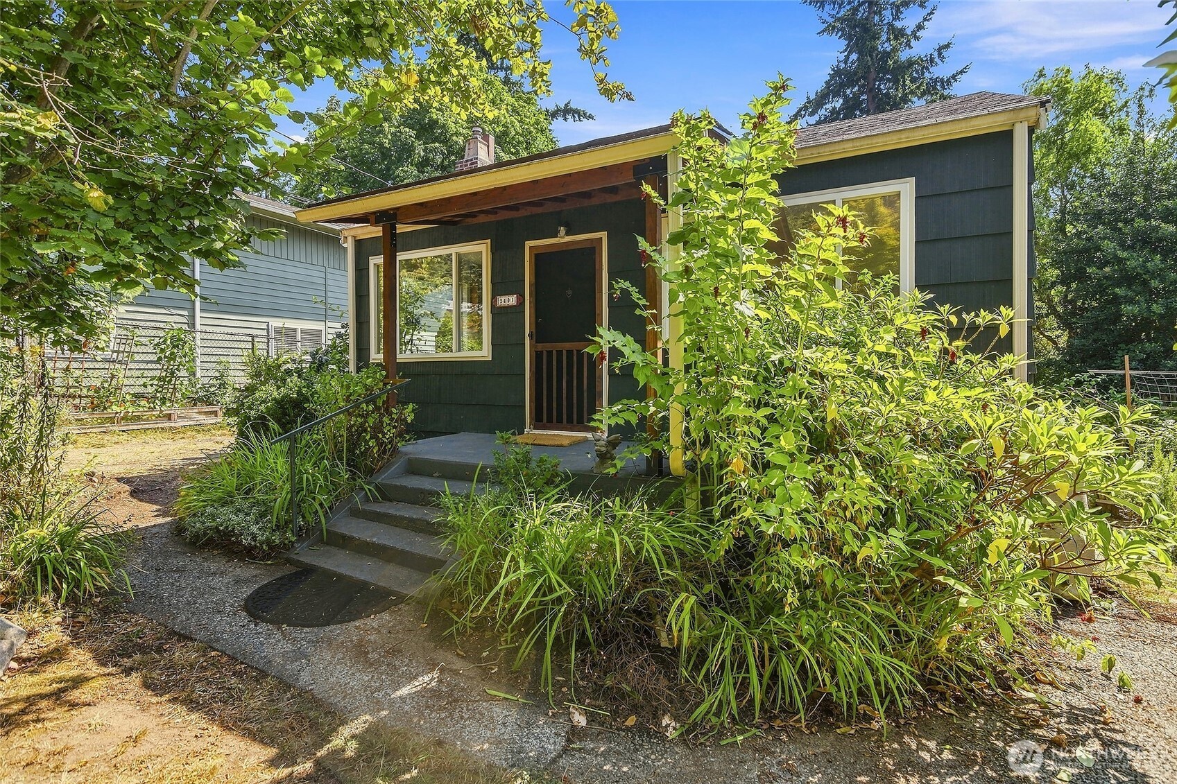 Welcome to this charming 1940 home set on a large 7800sqft lot in the Shorewood neighborhood.  The home boasts three bedrooms and two bathrooms and a large partially finished basement just waiting for further development. The gardens here are a paradise, an oasis and a refuge that must be seen. Berries, fruit trees, vegetables, flowers and a pond all make the outdoors here something special. Ok--the house: wood floors, original kitchen cabinets with natural birch fronts with arty pulls, custom stone fireplace surround with beautiful wood mantle, real wood paneled full bathroom and spacious sunlit kitchen. Turnkey is the word here--all systems go,  move right in.  ***Back on Market--buyer faced imminent job loss*** Don't miss out on this great house, now is your second chance!
