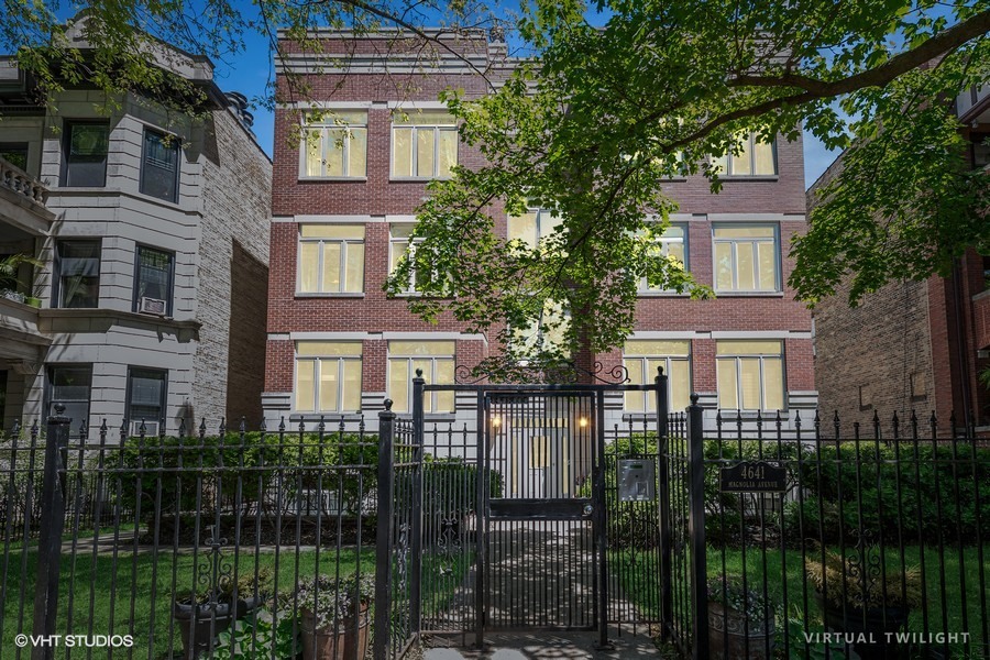 Welcome to your spacious, sun-filled 2-bedroom, 2-bath penthouse on leafy Magnolia, located in the heart of Sheridan Park.  Perched on top floor of an impressive all brick, boutique 8-unit building, this gracious condo offers a rare blend of classic warmth and modern vibes. Rehabbed in 2022 & with many improvements since, this home features gleaming deep brown oak floors,  and an open-concept layout ideal for entertaining. The expansive living and dining area with 12 foot ceiling is anchored by a cozy wood-burning fireplace and boasts stunning south & west exposures that flood the space with natural light. Room darkening top-down-bottom-up blinds control light & privacy.  The updated kitchen is a chef's dream with Kitchen Aid stainless  appliances, gas stove, abundant cabinets & quartz waterfall breakfast bar. The oversized primary suite features luxurious ensuite bath with double vanity and soaking tub, while the second bedroom is also generously sized & with great closet space.  There are 7 closets in #3S!  Enjoy the East facing deck for am/pm beverages, listening to the birds or growing a garden!  9X11 deck & covered! Additional features include a Laundry Room with extra storage area, central air, and one detached garage parking space-included in gated back area.  Located on stately tree-lined Magnolia, this home offers easy access to Red & Purple Line trains, lakefront paths, restaurants, Downstate Donuts, Target, Aldi, Corepower Yoga and all the vibrancy Sheridan Park, Uptown & Andersonville have to offer. Low HOA ($292/month), pet-friendly (policy is 1 dog, 1 cat, no weight restriction). All owner-occupied.  Rentals not allowed.  Post-closing possession for Seller not needed. Move right in & make this Magnolia Penthouse your own!