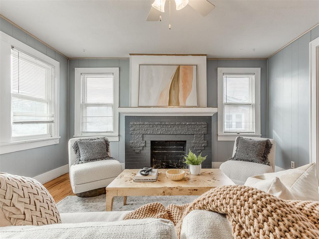 Tucked just steps from the Plaza District, this inviting home blends charm, comfort, and thoughtful updates. Warm hardwood floors lead you into a cozy living space centered around a fireplace—perfect for quiet evenings or gathering with loved ones. The updated kitchen features a gas stove, matching appliances, a large pantry, and a warm, functional layout ideal for everyday living.The home offers 3 bedrooms and 2 full bathrooms, including a comfortable primary suite with a spacious walk-in closet that also serves as the home’s laundry area. A versatile den or office adds flexible living space. Enjoy peace of mind with a 2020 HVAC system, a roof replaced in November 2019 by a licensed roofer with a 30-year shingle, the comfort of a tankless hot water heater providing endless hot water, and a below-ground storm shelter for added safety. Washer, dryer, and refrigerator are negotiable.Step outside to a spacious backyard ideal for relaxing or entertaining, along with a one-car garage with storage, carport, and additional storage shed. This home offers a rare opportunity to enjoy cozy living in one of the city’s most beloved, walkable neighborhoods.