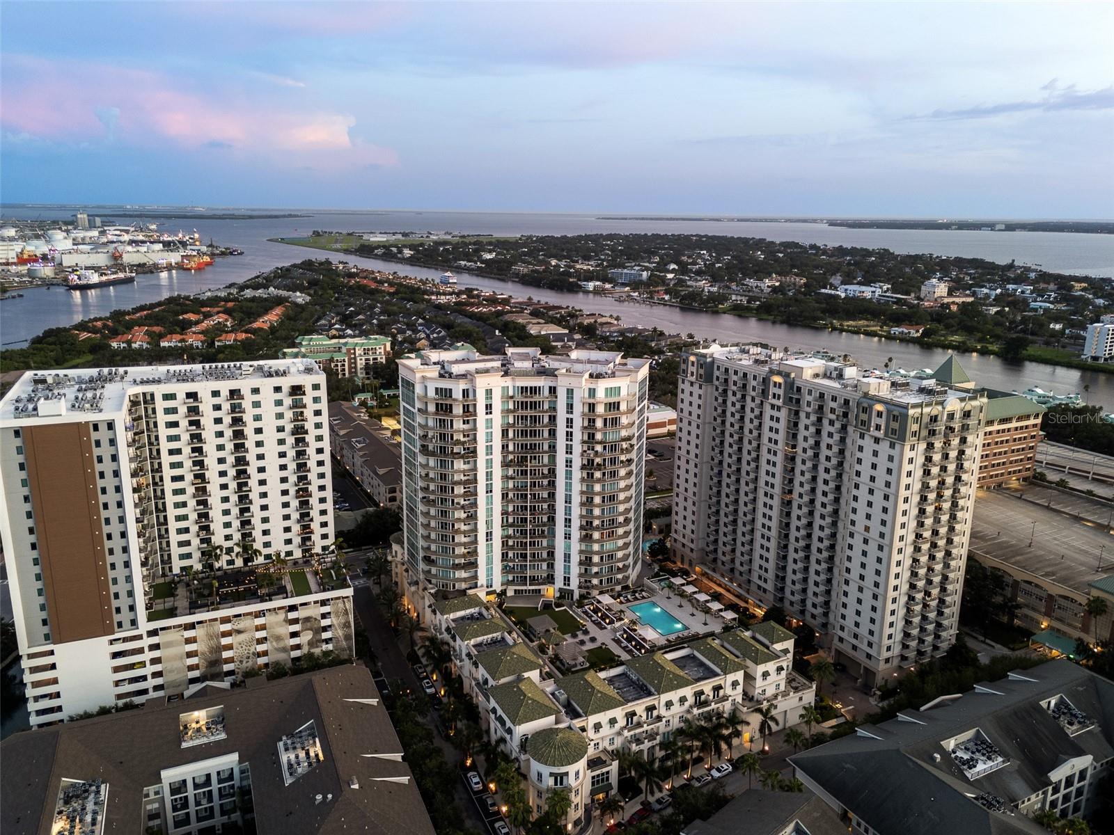 Discover sophisticated urban living in this exceptional residence at The Plaza on Harbour Island offering two suites and a third bedroom or office space. Your private elevator landing opens into a luxurious foyer, distinguished by a tray ceiling and gleaming hardwood flooring that extends throughout the open floor plan. The main living area is bright and bathed in natural light, thanks to floor-to-ceiling windows and glass sliding doors that create a seamless indoor-outdoor feel. An expansive gourmet kitchen is exquisitely updated with beautiful quartzite counters that follow up the backsplash, complemented with beautiful cabinetry. The primary bedroom is a retreat, offering panoramic floor-to-ceiling corner windows, elegant crown molding and two closets.  Completing the suite with the lavish bath was fully remodeled in 2021 featuring stunning vanities, a frameless glass walk-in shower and a deep soaking tub. The split floor plan ensures privacy for the guest suite, which includes southwest views over the oversized windows, crown molding and a large walk-in closet. A versatile third room, ideal for an office or additional bedroom, is enclosed by glass French doors and features an en-suite half bath. Other key features include modern fixtures, window treatments, walk-in pantry, built-out closets, 2024 tankless water heater, two parking spaces and storage locker. Go outside onto the spacious covered balcony to enjoy a relaxing sitting area, and scenic south-facing views over Harbour Island with cruise ships passing by. This residence is complemented by The Plaza’s full service amenities, including on-site valet parking, a concierge desk, various elegant lobby spaces, a well-equipped fitness center with a private treatment room and sauna, multiple business and meeting rooms, a theater and games room, a resort-style heated pool and spa with shaded cabanas, and a covered grilling station. With direct access to The Tampa River Walk, this building is pedestrian friendly to all dining and entertainment options, the Water Street District, Amalie Arena and downtown Tampa while also in the top-rated Gorrie, Wilson, Plant school district.