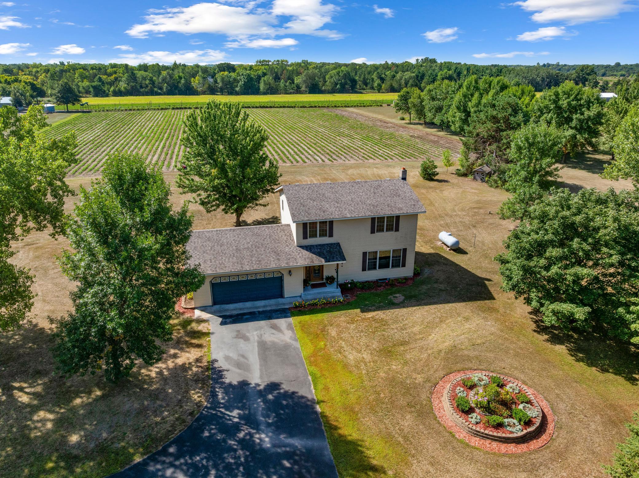 Rare opportunity to enjoy 5 private acres in an exceptional Monticello location—offering the peace and space of country living while keeping you just minutes from town, shopping, schools, restaurants and everyday conveniences. Take in beautiful views overlooking  strawberry fields and enjoy a setting where deer, turkeys and other wildlife are frequent visitors. The property offers plenty of room to spread out, garden, enjoy the outdoors or bring the horses, along with established hazelnut and pear trees. The 3-bedroom, 2-bath home features a newer roof and comfortable living spaces, while the unfinished portion of the lower level provides excellent potential to add additional finished square footage, bedrooms, recreation space or storage. Whether you're looking for acreage, privacy, room for animals or simply a little more breathing room without giving up convenience, this property delivers a hard-to-find combination of location, land and opportunity. Country living close to town—with views, wildlife and five acres to make your own.
