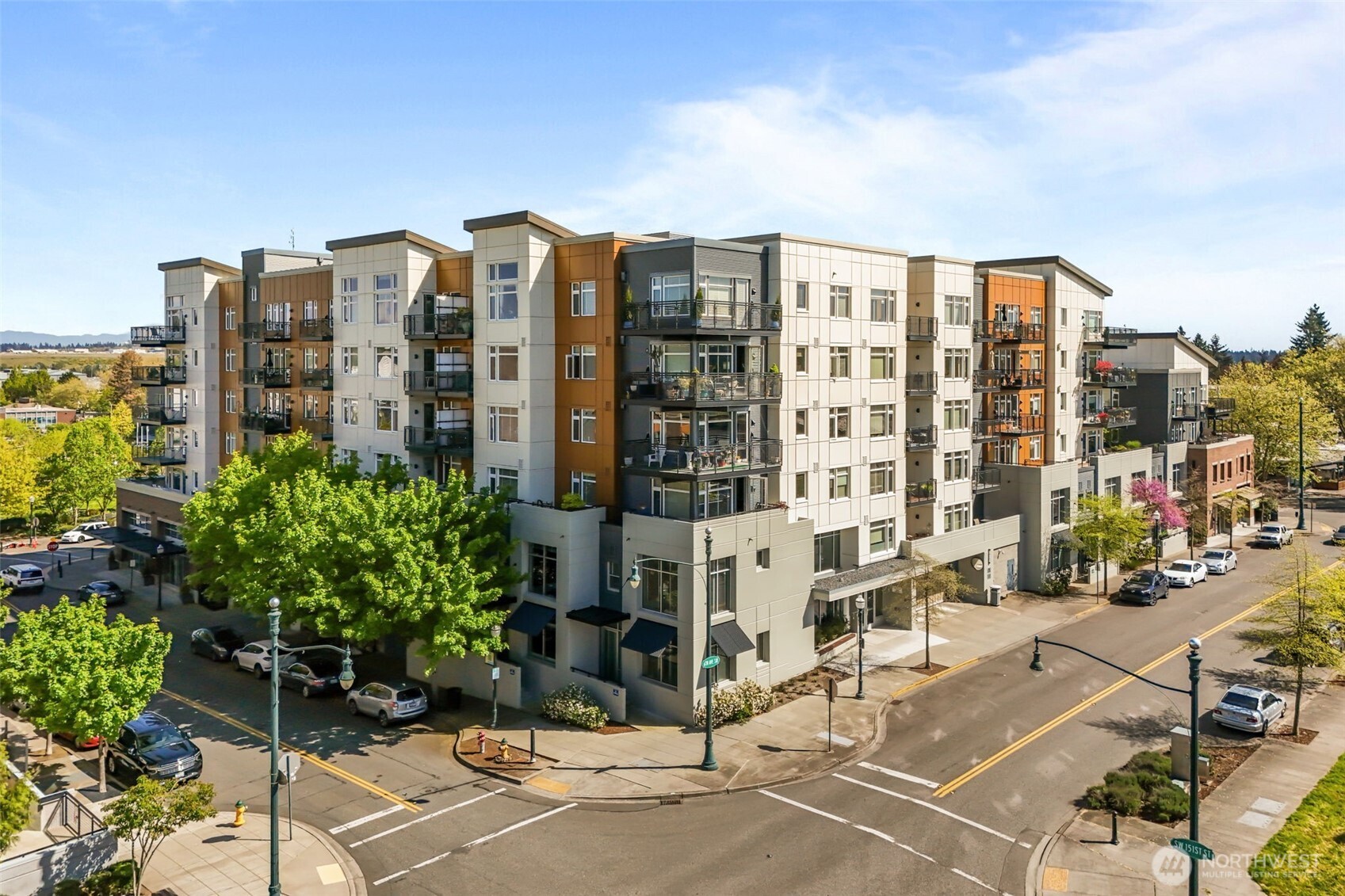 Spectacular and extremely rare ground-floor live/work loft condo located in upscale Burien Town Square. Enter through a secure lobby, or welcome clients directly through your own private street entrance. This two-level unit features soaring ceilings and a spacious open-concept design filled with natural light. The main floor offers a bright kitchen with a gas cooktop, a large living area, half bath, in-unit laundry, and expansive windows. Enjoy modern urban style with concrete floors, cable railings, and sleek industrial finishes. Upstairs, the loft-style bedroom includes a generous full bath and two closets. Community amenities include a secure lobby, assigned parking with conveniently located storage, a rooftop garden, courtyard, fitness center, BBQ area, and a community room with kitchen.