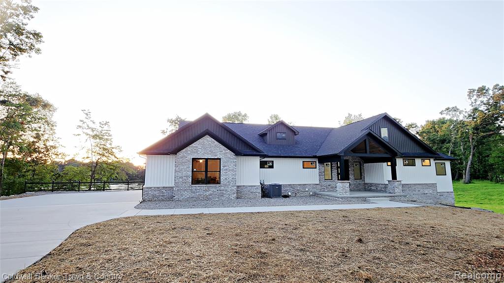 Almost Done! Now is the Time to Make It Yours!

This stunning, custom-built home is nearly complete and ready to impress, with over 540 feet of private lake frontage on scenic Lake Lochmoor. Set on nearly 2 acres at the end of a quiet cul-de-sac, it’s a peaceful escape with space for private trails and sunset views.

With 5 bedrooms and 3.5 baths, the home blends elegance and function. A covered front porch welcomes you, and the Trex deck is ideal for enjoying lake views.

Inside, the open-concept layout is filled with natural light from Andersen windows and flows into the finished walkout basement. Expansive windows wrap the lower level, showcasing the outdoors from every angle. This bright, airy space feels like a continuation of the main living area, fully connected to the lake and landscape.

The great room features vaulted ceilings with beams, a fireplace, and recessed lighting. The kitchen includes Quartz counters, a 48-inch gas stove with hood vented outside, and a grand island. The main-floor primary suite offers dual walk-in closets, double vanities, and a spa-style shower. Two additional bedrooms share a Jack and Jill bath.

Main-level features also include a mudroom, half bath, and spacious laundry room.

The walkout basement includes a rec area, game room, two bedrooms, full bath, and ample storage. A wet bar or second kitchen is roughed in—perfect for guests or an in-law suite.

The oversized 3+ car garage is fully insulated, drywalled, and includes openers. All located in a quiet, paved neighborhood just 6 minutes from I-96, with access to Ann Arbor, Lansing, and Metro Detroit.

More than a home—it’s a lakeside lifestyle crafted with light, quality, and natural beauty.

Please note: Exterior photos show the actual home. Interior photos are from past builds by the same builder with similar layouts and finishes.