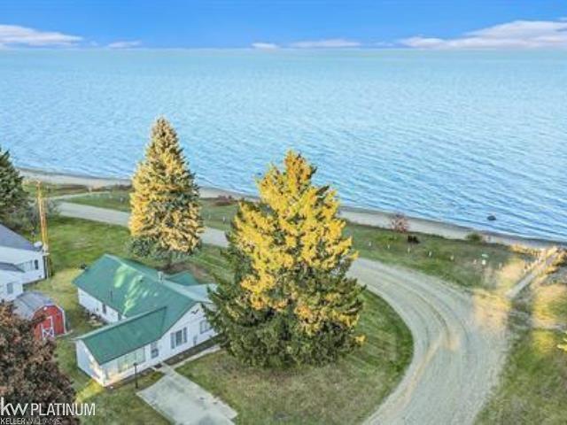 Lakefront living-without the lakefront taxes! Enjoy the best of both worlds in this beautifully updated 2-3-bedroom, 1-bath home, just steps from stunning Lake Huron. Nearly professionally renovated just three years ago, this home is move-in ready and in excellent working order. Recent updates include a durable 2-year-old steel roof, giving you peace of mind for years to come. Take in uninterrupted views of the lake-nothing stands between you and those breathtaking sunrises. Leave the hustle behind and unwind in this private setting, complete with access to expansive sandy beach frontage. Whether you're looking for a year-round home or a peaceful getaway, this one delivers simple, classic lakeside living the way it ought to be.