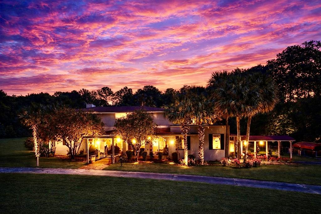 High-Speed Internet Available!  A true Quitman landmark, this beautiful Spanish-style residence sits on an elegant 3.04-acre setting in the heart of historic Quitman. Surrounded by palm trees and mature landscaping, the property offers a rare combination of architectural character, space, and versatility.  Currently used as a private residence, the property is zoned General Business, allowing for a variety of potential commercial uses such as professional offices, boutique lodging, event space, or other business opportunities.  Inside, the home offers generous living spaces and classic charm, including a large living room, formal dining room, and a comfortable family room with fireplace. An expansive entertainment room provides additional space for gatherings and hosting.  The spacious primary suite features a walk-in closet and luxury bath, creating a private retreat within the home.  With its iconic Spanish architecture, prime location, flexible zoning, and beautiful acreage, this property presents a unique opportunity to own one of Quitman's most distinctive homes.