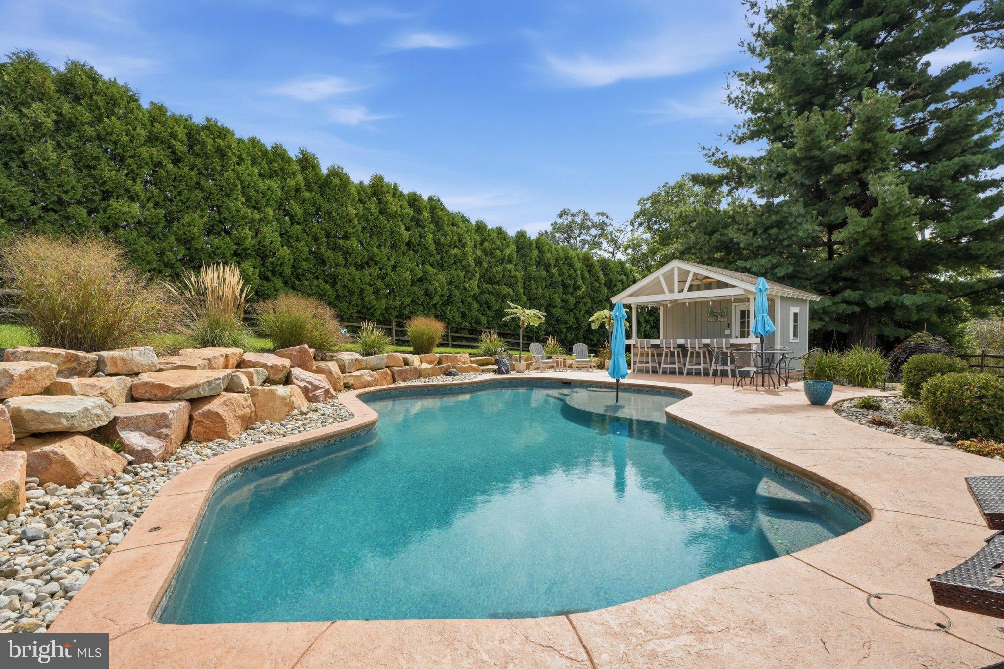 If you have been dreaming of a home with an incredible private outdoor retreat, this is the one you've been waiting for! Step into your own backyard oasis featuring a sparkling, heated, inground saltwater pool, only two years old, with approximately 20,000 gallons, a sun shelf, and beautiful pebble finish. The oversized stamped-concrete pool deck, mature landscaping, and privacy trees create a peaceful and secluded setting that is perfect for summer relaxation, entertaining, and making memories. A custom-built tiki bar adds the perfect touch for gatherings and also provides convenient pool storage. A paver patio offers additional seating and a fire pit area, while beautifully landscaped rock beds add to the incredible setting. A spacious deck and enclosed, heated and cooled sunroom provide even more ways to enjoy this exceptional outdoor living space. This backyard was thoughtfully designed for entertaining, relaxing, and enjoying outdoor living at its very best.Inside, this charming Cape Cod offers a wonderful combination of updates, character, and functionality. The updated kitchen features an island with seating, granite countertops, soft-close cabinetry, stone backsplash, and stainless steel appliances replaced in 2021. The dining room is conveniently located just off the kitchen, making entertaining easy. Luxury vinyl flooring was installed throughout the first floor in 2022, which also includes a comfortable living room, powder room, and the beautiful heated and cooled sunroom overlooking the backyard.The second floor offers two spacious bedrooms with ample storage and a full bathroom, with carpeting replaced in 2024. The partially finished basement provides valuable additional living space, including a third bedroom, family room, full bathroom, and multiple storage areas, plus a convenient walk-up exterior entrance.Additional highlights include a one-car garage with epoxy-finished floor, 200-amp electrical service, updated six-panel doors, roof replaced in 2019, water heater and furnace replaced in 2022, second AC system replaced in 2022, new garage door and opener in 2024, and a whole-house generator installed in 2023.A truly special property where the exceptional backyard, inviting interior, and numerous updates come together to create a home designed for both everyday living and unforgettable entertaining.
