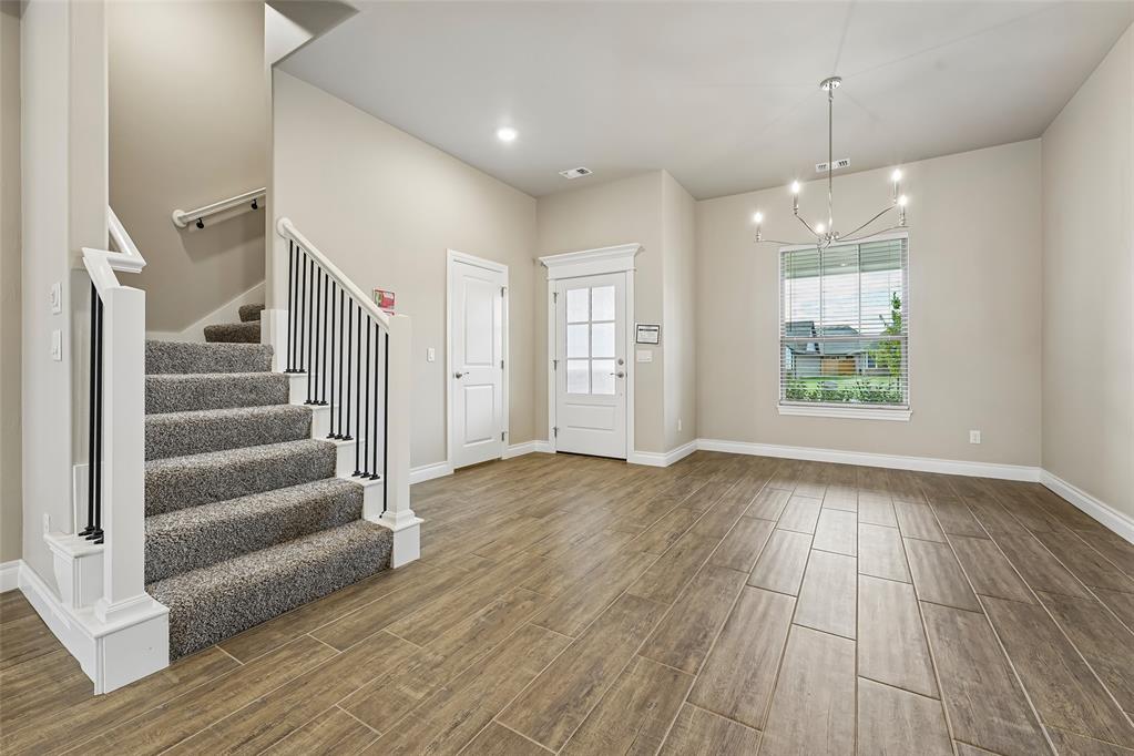 FENCING AND BLINDS INCLUDED! This Poppey Bonus Room 5 Bedroom floor plan includes 3,700 Sqft of total living space, which includes 3,350 Sqft of indoor living and 350 Sqft of outdoor living. This home offers 5 bedrooms, 3 full baths, a powder room, a bonus room, a study, a utility room featuring a utility sink, 2 dining areas, and a 3-car garage with an in-ground storm shelter installed. The great room presents a breathtaking coffered ceiling with crown molding and a ceiling fan, wood-look tile, large windows, rocker switches and eggshell paint throughout, and Cat6 wiring. The high-end kitchen supports 3 CM countertops, well-crafted cabinets to the ceiling with under cabinet lighting and cabinet hardware installed throughout, stainless steel appliances, a 5-burner cooktop, double ovens, a center island with a trash can pullout, gleaming tile backsplash, a separate corner pantry, and stunning pendant lighting. We also included a 3-panel sliding door with a 4’ back patio extension at the breakfast nook. The primary suite boasts a sloped ceiling with a fan, windows, Cat6 wiring, and our cozy carpet finish. The spa-like primary bath features separate vanities with framed mirrors, 3 CM countertops, a private water closet, a free-standing tub, a European walk-in shower, modern tile flooring, and a HUGE walk-in closet. Secondary bedrooms feature ceiling fans, windows, sizeable closets, and carpeted flooring. The covered outdoor living area includes a wood-burning fireplace, a TV hook up, and a gas line. Other amenities include our healthy home technology, a tankless water heater, a whole home air filtration system, R-44 insulation, and so much more.