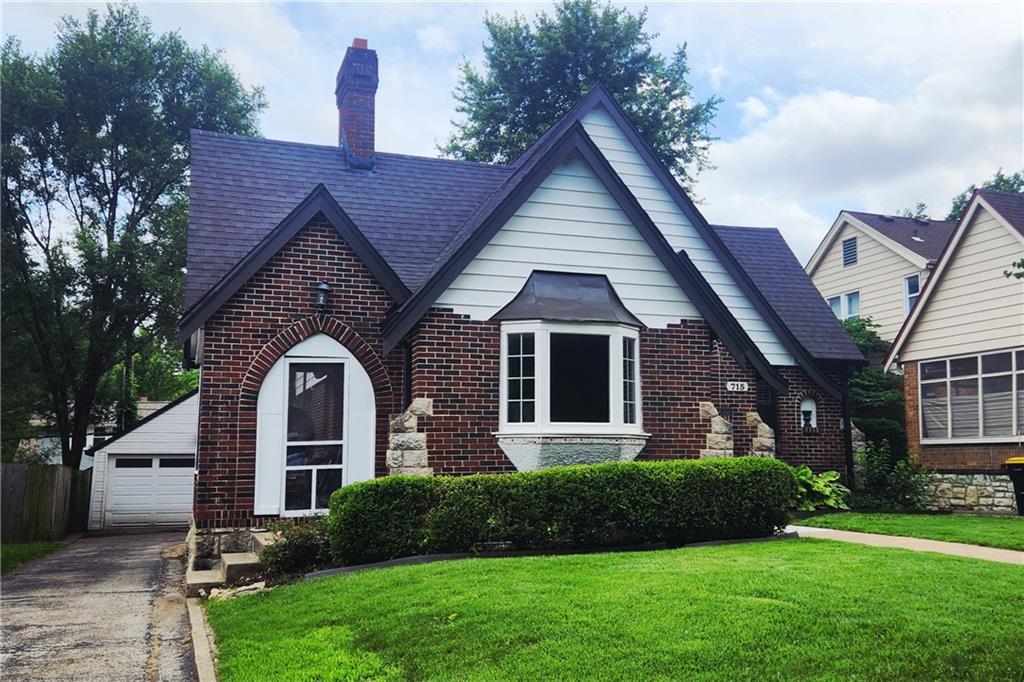 This beautiful Waldo Tudor perfectly combines the best of the 1920's with today's amenities! The exterior has brick and stone architectural details while the interior has charming archways, moldings, and tile work. Beautiful hardwoods throughout! Kitchen has quartz countertops and is complemented by original tile work.  Main level bedroom and full bathroom on the main level. 3 bedrooms and 1 full bathroom on 2nd level provide many floor plan options. BONUS finished rec room in the basement. Easy entertaining with the screened-in side porch and back deck with pergola. 2 car garage with private drive!   Perfect location that’s walkable to the shops on Gregory and close to Brookside shops!