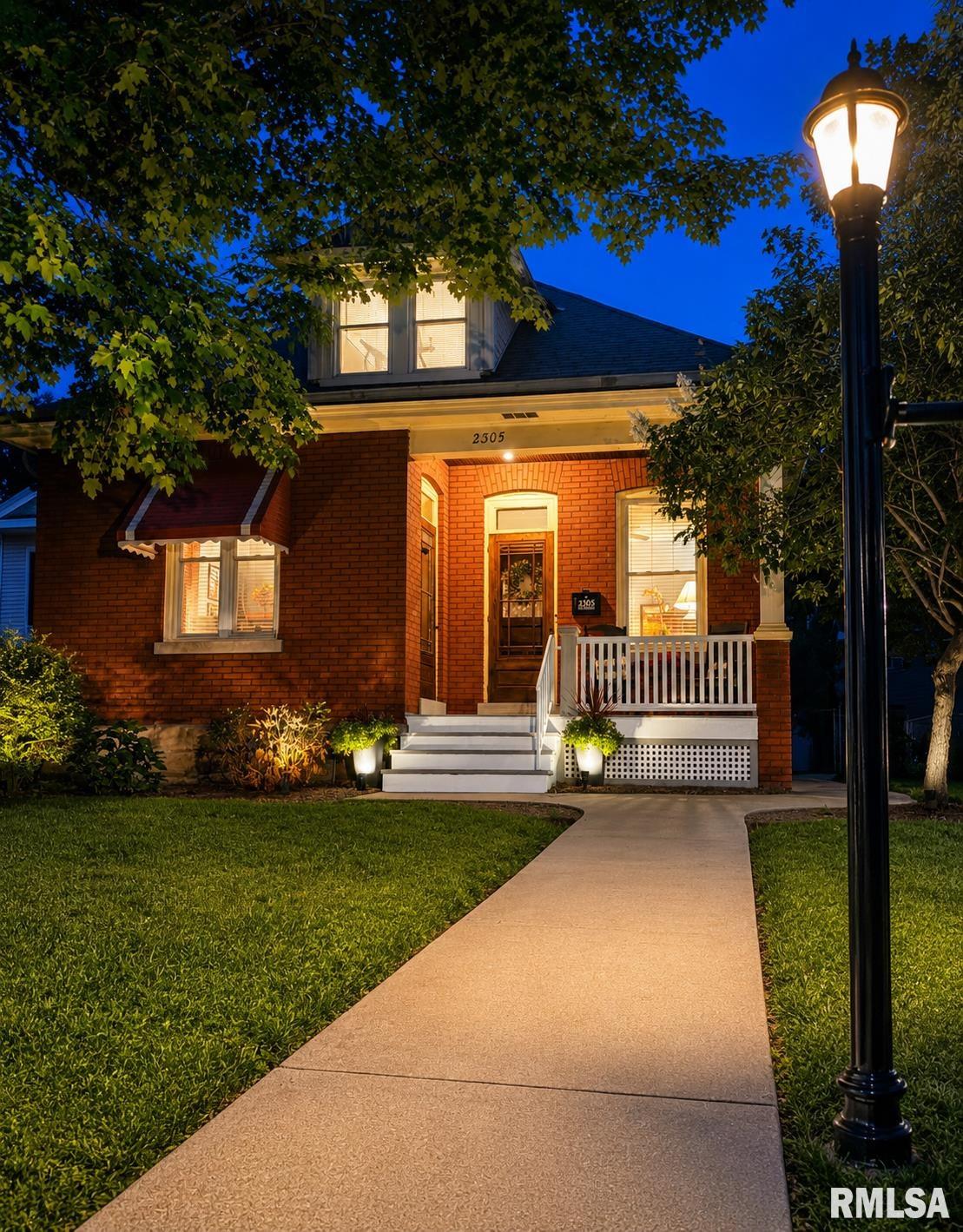 This well-maintained 4-bedroom, 1.5-bath brick bungalow retains much of its original character. Step inside to original woodwork, high ceilings, and rooms with warmth and personality, complemented by practical updates. The kitchen provides plenty of storage, including a custom pull-out pantry with a built-in, lighted rotating spice rack. Two main-floor bedrooms have cedar-lined closets. Upstairs are two additional bedrooms, including a versatile space with a sitting area ideal for reading, relaxing, or a home office. Outdoor spaces include a front porch with a newly replaced and painted floor, enclosed back porch, shaded brick patio, deck, spacious fenced backyard, mature landscaping, and evening exterior lighting. The detached 2-car garage is accessible from the alley. Recent improvements include complete exterior tuckpointing (2026), vinyl double-pane replacement windows, and professionally cleaned HVAC ductwork.