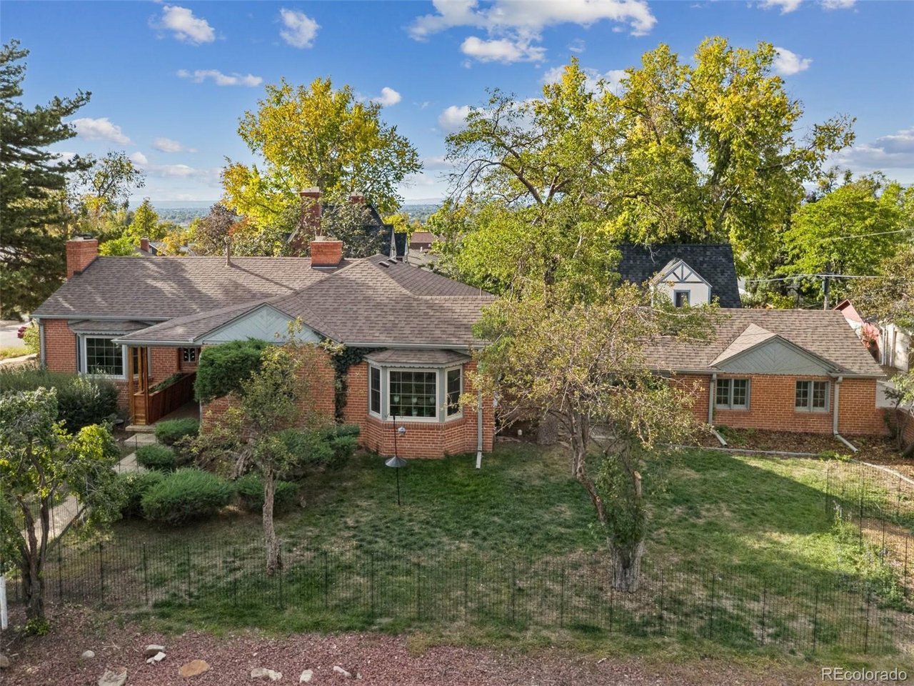 Charming brick ranch in Wheat Ridge offering the perfect blend of vintage character and thoughtful updates. Situated on a large corner lot, this 3-bedroom, 2-bath home features great natural light, recently refinished floors, and a true main-floor office. The updated kitchen is a standout with an ILVE gas range and Big Chill refrigerator, adding distinctive style and quality to the space. The finished basement provides flexible additional living space with room for a living area, kitchenette, office, and full bathroom. A unique lanai connects the home to the 2-car garage, creating an inviting space for relaxing or entertaining. The spacious corner lot offers plenty of room for outdoor enjoyment, gardening, or play. A special Wheat Ridge home with character, functionality, and updates in all the right places.
