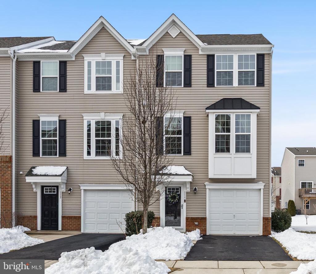 Tucked into the sought after community of the Cinnaminson Harbour, this exceptional end unit townhome is located within the Water Club, the newest section of the neighborhood. It offers the kind of space, light, and thoughtful upgrades that are rarely found in a townhome setting. Spanning roughly 2,500 square feet across three levels, the home features three bedrooms, two full bathrooms, and two half baths, along with the added benefit of being an end unit that allows sunlight to pour in from multiple exposures.The entry level offers exceptional versatility, featuring a welcoming foyer, a convenient half bath, and access to the rear patio. This outdoor space provides another area to relax or entertain and creates a seamless connection between indoor and outdoor living.Step upstairs to find a bright and welcoming main living level finished with engineered hardwood floors, recessed lighting, and an open layout that feels both comfortable and refined. The living and dining areas flow naturally into a generously sized kitchen. White shaker cabinetry, stainless steel appliances, an oversized island with breakfast bar seating, and an abundance of counter space make this kitchen the true heart of the home. A pantry with double doors provides excellent storage, while a custom coffee bar with glass cabinetry adds a thoughtful touch that feels both stylish and practical. A conveniently located half bath completes this level.Just off the kitchen, sliding doors lead to a beautiful deck where you can enjoy fresh air and partial river views. It is an ideal spot for morning coffee, outdoor dining, or simply unwinding at the end of the day.The upper level is home to three spacious bedrooms, including a comfortable, private primary suite. The ensuite bathroom features ceramic tile flooring, a double vanity, a soaking tub, and a separate stall shower. Two additional bedrooms share a well-appointed full bathroom, completing the top floor.Additional highlights include an attached one car garage, private driveway parking, and ample guest parking throughout the community. Amenities include a fitness center, swimming pool, paved walking path by the river, and tennis and pickle ball courts. The community is located a stone’s throw from the Riverline - a convenient commuter train.With multiple outdoor spaces, river views, and a bright end unit layout, this home offers a unique combination of comfort and style in one of Cinnaminson’s most desirable neighborhoods. If you have been searching for a spacious townhome with great natural light, thoughtful upgrades, and a welcoming community setting, 115 Fela Drive is a home you will not want to miss!