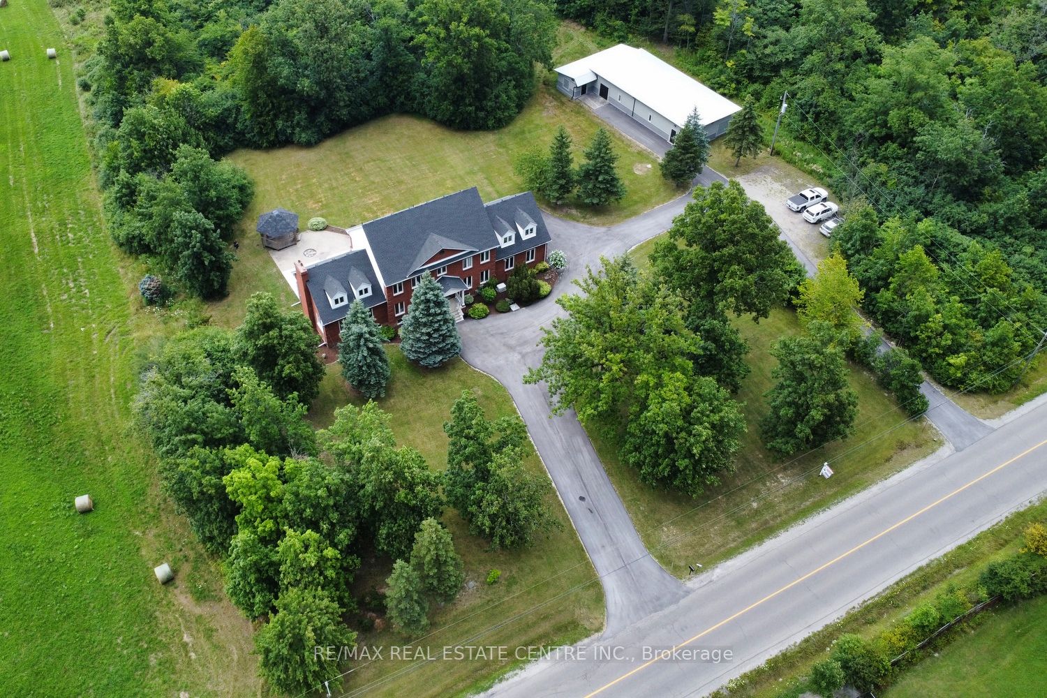 A True Piece of Paradise. Welcome to your dream home, a picturesque oasis surrounded by nature on an expansive 8.3-acre corner lot. With 592 ft. X 600 ft. lot, this property offers the perfect blend of country living and modern convenience. Just minutes away from all amenities. This extensively renovated family home boasts over 7,000 sq. ft. of luxurious living space. Step inside to discover 5 + 2 spacious bedrooms and 3 full bathrooms. The main floor features an elegant office, and an XL family room with a fireplace, a perfect setting for relaxation and entertainment. The finished basement, with a separate entrance, adds additional space for family or guests. The property includes an oversized dble. garage with heat, a paved circular driveway that can accommodate 20+ vehicles. Other features include a 3600-gal. cistern, 400-amp, and security system with cameras. Enjoy the serene and private backyard, complete with a firepit, gazebo, and plenty of room for outdoor activities. This property also includes a separate 1,950 sq. ft. studio/workshop/In-law equipped with a steel roof, heat, hydro, a bathroom, kitchenette, its own 2,200-gallon cistern. The buildings interior is a blank canvas awaiting your design vision. This property presents an excellent opportunity for a multiple-family setup, investors, or developers looking for a unique and versatile space. Don't miss the chance to own this stunning piece of paradise with endless possibilities this property has to offer.
