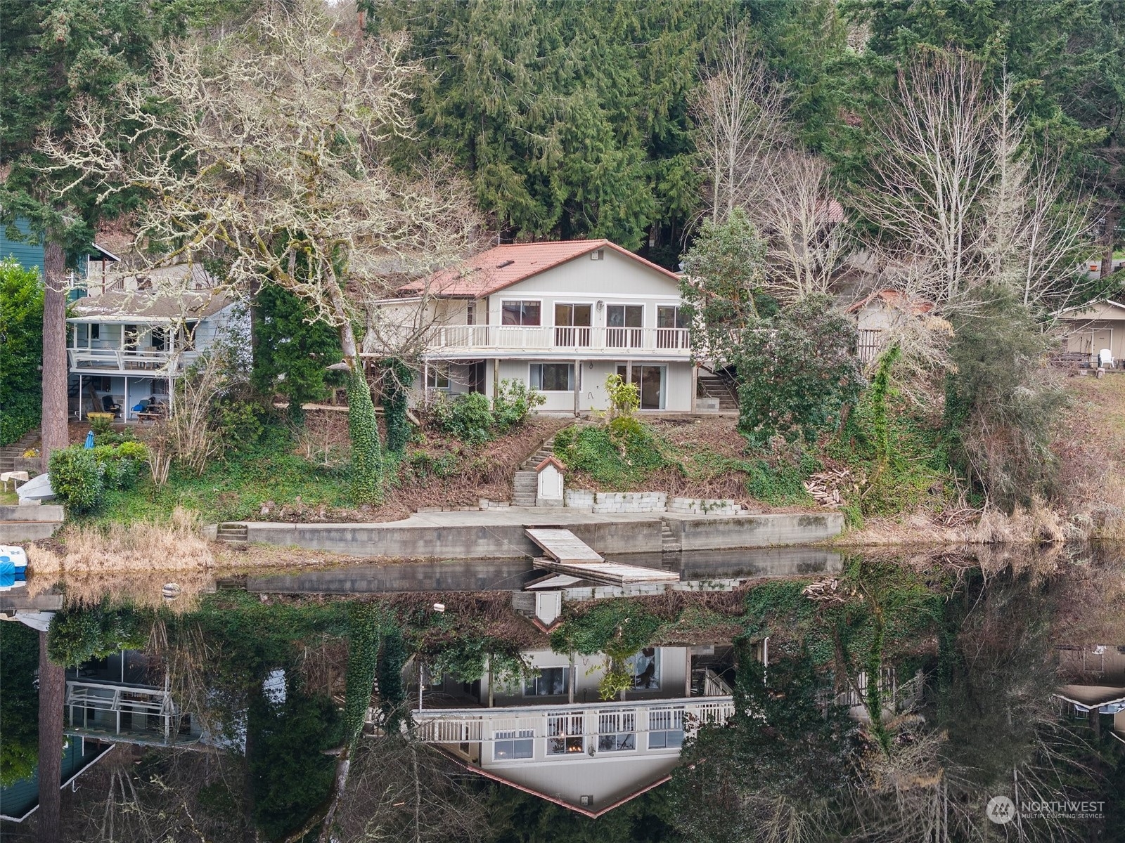 SALE FAILED DUE TO BUYER LOSING FINANCING. Welcome to a Mediterranean-inspired retreat on the tranquil shores of Lake St. Clair. Nestled on almost 1 acre w/ 108 feet of waterfront! The main floor living design provides convenience + accessibility, w/ expansive windows framing the breathtaking, year-round views of Dollar Island and the lush PNW foliage that surrounds you. The scenery is always picture-perfect! A rare concrete bulkhead offers protection while providing easy access to the serene waters of Lake St. Clair, ideal for relaxing or fishing from your own shores. The garden flourishes w/ springtime blooms, and the charming grape arbor adds a touch of Old World elegance. SHOP, chicken coop and an interior canvas ready for your personal touches awaits.