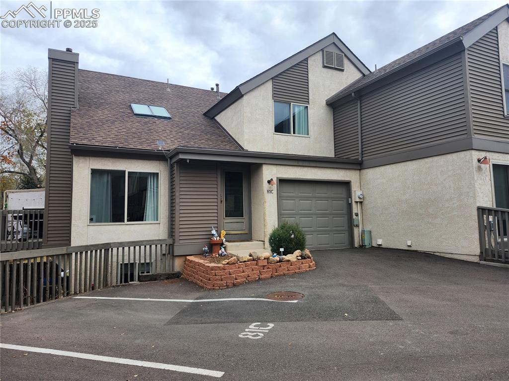 Open & bright end unit in the rear of the complex with 1566 sq ft - 2 beds, 2 1/2 baths, den, family room, walk out basement- Central Air - Pikes Peak view from both upper level bedrooms & living room. Finished attached oversized 1 car garage & 1 assigned parking space right next to the unit - Vaulted living room - 2 skylights - Gas log fireplace with mantle- Updated kitchen & baths. 2nd bedroom is a loft with privacy partition- Family room in walk out basement is divided into a den (currently used as 3rd bedroom but is non-conforming) & can be 1 big family  room (24x12) with walk in closet ~ deck off dining area & patio off family room- freshly painted