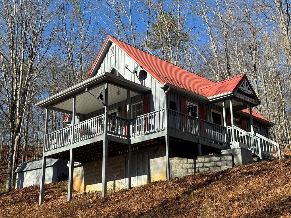 Mountain getaway close to Burke's Garden, New River Gorge, and the Blue Ridge Mountains.  Tucked away in the forest on 2.55 acres sits this lovely cabin retreat.  Private, secluded wooded property with lovely views of the surrounding Jefferson Forest.  Featuring 2 bedrooms, 1 bathroom, and kitchen that includes all appliances including a washer and dryer and plenty of room for a dining table close by.  The bathroom was updated in 2023 and there is a new water heater and water softening system for the property's artesian well.  Two large porches (one covered) provide outdoor living at its best with lots of room for watching the seasons and the sunsets.  Detached from the house, there is a large storage shed as well as a small, covered deck for grilling and entertaining.  The wood-burning Fisher stove provides warmth and comfort in the winter and a lovely centerpiece for the home's living area.  Parquet floors throughout the home.  The upstairs bedroom features a walkway with a large picture window and small seating area.  Only 10 miles miles off the interstate along the scenic Wolf Creek Valley and within 25 minutes of Bland and Tazwell, this sweet cottage makes for a great home, wooded retreat cabin, or primary residence.