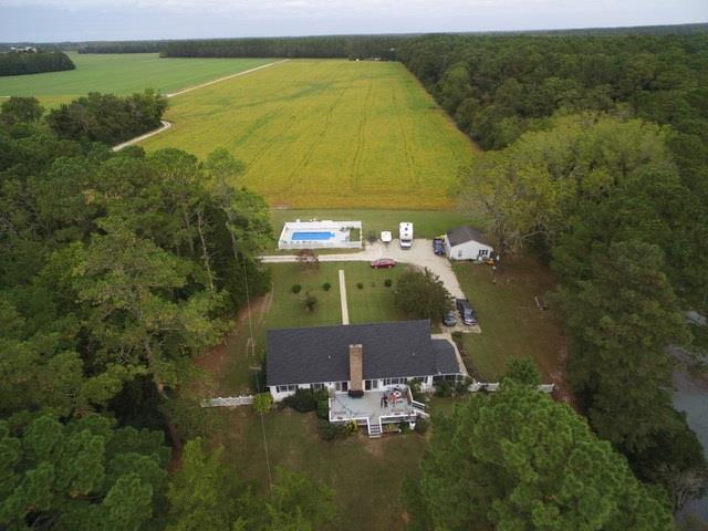 Secluded home with 14 x 28 in-ground, heated, salt water pool located off the beaten path on Folly Creek.  Over 3 acres provides lots of privacy in this 4 bedroom, 3 bath creek front home.  Spacious areas for flower and/or vegetable gardens ... Abundance of wildlife and birds for the nature enthusiast.  Two bedrooms and bath upstairs and two bedrooms with two baths downstairs; one is the main bedroom including en suite bath with walk in shower ... additional room downstairs is currently being used as a study.  This home has been updated to include luxury vinyl flooring in the living room, dining room, downstairs hall & bedrooms. Downstairs HVAC recently replaced.  Creek side yard recently fenced. Greenhouse does not convey. MOTIVATED SELLERS !!!!
