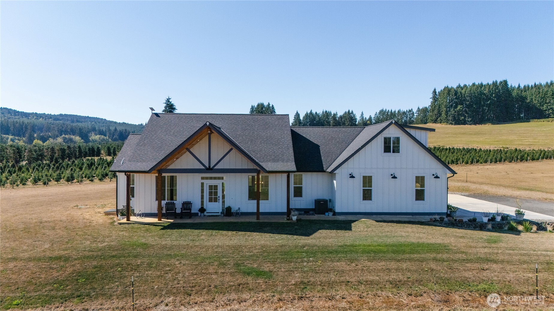 Experience luxury country living on 5 breathtaking acres with sweeping mountain views and unforgettable sunsets. Built in 2023, this stunning modern farmhouse blends timeless design with exceptional craftsmanship, featuring granite countertops, stainless steel appliances, a double oven, and 10-foot ceilings throughout. The impressive living room is the heart of the home with soaring 18-foot vaulted ceilings, exposed beams, and a gas fireplace that creates the perfect atmosphere for cozy fall evenings. Offering 3 bedrooms plus a spacious bonus room and an office, there's plenty of flexibility for guests, or recreation. The oversized primary suite features a spa-inspired bathroom complete with a jetted soaking tub and custom tile shower, while the guest bath includes a double vanity for added convenience. Outside, 5 lush acres of vibrant green pasture provide the perfect canvas for an equestrian lifestyle or hobby farm, all with the aesthetics to match. Backing to a large private timber company, this property offers outstanding privacy in a prime location where homes rarely become available. Sit under the tongue and groove back patio and watch the sunset, without a neighbor in site!  This is the country lifestyle you've been waiting for.