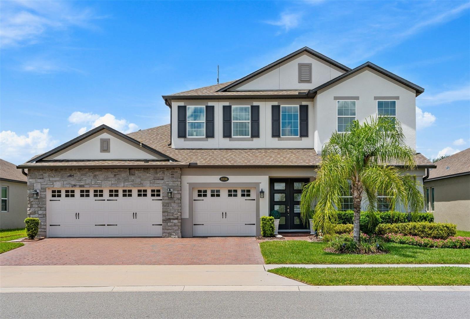 Virtually Staged. Built in 2022 and UPGRADED from top to bottom, this stunning Tradewinds model M/I Home is a 4-bedroom, 3.5-bath POOL HOME in the gated Red Ember North community, that delivers the look and feel of a model home with an exceptional Oviedo location! The RESORT STYLE POOL and SCREEN ENCLOSURE were added in 2023 – complete with solar heat, fountains, fire features, an extended paver patio, wired tiki torches and lush privacy landscaping. Inside, elevated builder finishes and thoughtful owner updates continue throughout, including WOOD LOOK PLANK TILE FLOORING, upgraded cabinetry and countertops, 8’ interior doors, crown molding, designer lighting and statement accent walls. Natural light fills the spacious OPEN CONCEPT main floor, where oversized living and entertaining spaces flow effortlessly together. The family room makes an impression with a STACKED STONE FEATURE WALL and BUILT-IN ELECTRIC FIREPLACE, while the dining room features a magazine worthy coffered ceiling. The kitchen is equally polished with upgraded cabinetry, sleek countertops, pendant lighting and a backsplash extended to the ceiling. Glass French doors open to a DEDICATED OFFICE (or flex space!), while a MEDIA ROOM and additional versatile spaces provide plenty of room to work, relax or entertain. The generous MAIN FLOOR PRIMARY SUITE is complemented by a spa-inspired en-suite bath featuring tiled walls, a FREESTANDING SOAKING TUB and SEAMLESS GLASS ENCLOSED WALK-IN SHOWER. Upstairs, slatted accent panels add custom style to the loft and media spaces. With 4 bedrooms PLUS an office and media room, 3.5 baths and a 3-car garage, this floor plan offers exceptional flexibility without sacrificing its open, airy feel. Outside, an oasis awaits designed for year-round Florida living. The fully screened, SOLAR HEATED POOL, fountains, FIRE FEATURES, extended sealed pavers, UPGRADED LANDSCAPING, bamboo privacy screening and outdoor lighting create a private resort-style retreat. Enhanced landscaping, DECORATIVE GLASS FRONT DOORS and sealed pavers add standout CURB APPEAL to the front as well. Located in Red Ember North of sought-after Oviedo, this GATED COMMUNITY is ZONED FOR TOP-RATED Seminole County schools, including walkable Hagerty High School, with trails nearby and UCF just minutes away. Easy access to Lockwood Blvd, McCulloch Rd and SR 434 keeps shopping, dining, Research Park and everything Oviedo within convenient reach. Spacious, upgraded and designed for entertaining, this home brings together luxury finishes, flexible living space and an unforgettable poolside lifestyle. Call today to schedule a tour and fall in love with your new HOME SWEET HOME!