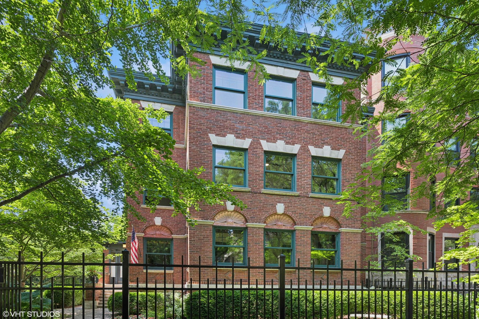 Amazing penthouse condo! This is the one you've been waiting for! Welcome to a truly rare condominium, perfectly positioned on one of the most charming streets in Uptown/Sheridan Park. Built in 1912, this architectural gem sits on an expansive 50' x 165' lot, offering nearly 2,200 square feet of single-level living with 3 bedrooms, a den, and a sunroom. Freshly updated and move-in ready, the home boasts a flowing floor plan with oversized rooms-ideal for both everyday living and grand entertaining. From the moment you arrive, the property impresses. Lush landscaping frames the entrance, leading you into a gracious foyer that anchors the home. The 20' x 14' living room features a wood-burning fireplace, custom glass-paneled built-ins with beadboard accents, and original stained-glass windows that bathe the space in southern light. Just beyond, an expansive den with a closet easily doubles as a fourth bedroom. Off the front of the home, a spectacularly large sunroom enclosed with French doors provides limitless options-dual offices, a yoga studio, playroom, workout space... whatever you can imagine.  At the heart of the home, the serene primary suite offers a peaceful retreat with four closets and an updated bath featuring classic white tile, designer lighting, and updated fixtures. The formal dining room is pure elegance-seating eight comfortably, framed by a south-facing picture window and original built-in hutch.    Two additional bedrooms include one with an en-suite bath featuring a clawfoot tub, hexagonal tile flooring, and pedestal sink, while the other includes a half bath and closet-perfect for a guest room or office. The spacious kitchen seamlessly blends old and new with brand-new KitchenAid stainless appliances, quartz counters and backsplash, and an early 1900s built-in hutch as a feature wall. A large covered deck extends the living space outdoors, perfect for morning coffee or evening wine.  The backyard is an entertainer's dream: stone pavers, cafe lighting, bench seating, and lush landscaping create a magical retreat. All this, just a short walk to the lakefront, the Red/Purple Line, Sheridan Park's historic charm, and countless restaurants with alfresco dining. Additional amenities include garage parking, a massive storage room, and the option for a second garage space and a second extra large storage room. One garage space included in price.  Second garage space available for purchase.