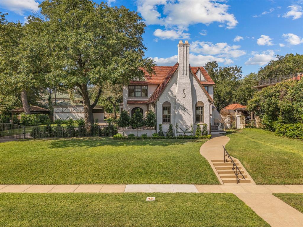 Not all renovations are created equal! This 1929 storybook home has been taken to the studs and revived with unmatched vision, a craftsman’s eye, and a designer’s touch. Its crisp painted façade, pitched rooflines, and original Ludowici clay tile roof—enhanced with an Ice Shield water barrier, copper gutters, non-lacquered copper lighting, and all-new Anderson windows and Durango doors—create stunning curb appeal. Taken to the studs, the home was completely renovated with new electrical, plumbing, and a reimagined layout for today’s living. The kitchen is a showpiece with dual pantries, AGA 3-oven range, custom brass-and-stainless vent hood, a charming breakfast nook and herringbone hardwood floors. The formal dining room is anchored by the home’s original restored Waterford chandelier, while Durango doors open to a patio shared with the living room. Dramatic designer lighting and a honed marble fireplace surround imported from Italy define the light filled living area.. Upstairs, the primary suite offers custom built-ins, spa-like bath with marble counters, dual vanities, and walk-in California Closet. Three additional en-suite bedrooms provide built-ins wardrobes. California closets cabinetry in all bedrooms and laundry room. The lower level has been transformed with an open living area, insulated cedar wine cellar, powder bath, extensive cabinetry, and add’l laundry space. Fully renovated with cement walls, ceilings, and water barrier, it’s perfect for entertaining and storage. Outdoor living impresses with bricked patios, porches, and a covered drive redesigned as a luxury entertaining area with Twin Eagle pellet grill and cabinetry. Upgrades include new sewer line, leak defense system, Carrier HVAC units, Navien tankless water heaters, closed-cell foam encapsulation, and whole-house water filtration. This rare gem combines timeless character with high-end modern updates—meticulously renewed and move-in ready. *Full list of home features available.