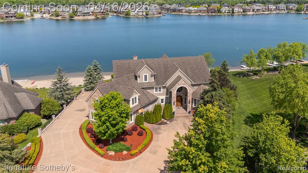 Magnificent, sprawling, custom built home ideally located with a panoramic lake view on Hidden Lake’s finest lot.  Intricate, stunning staircase leading to 2 primary suites with mood lit tray ceilings, fireplaces and balconies overlooking Hidden Lake. Hydronic in floor radiant heating throughout including driveway and sidewalks!  Main floor features a breakfast nook leading to the large deck with lake view.  Home features an elevator to reach each level and boasts a 6 car heated garage.  Wonderfully unique features including private home theater, indoor swimming pool, hot tub and sauna, sophisticated library and an elegant wine cellar amongst countless other stunning features.   Lower level with walk-out full kitchen, dance floor, gaming and workout area.  Beautiful landscaping adorns this idyllic lakefront home.