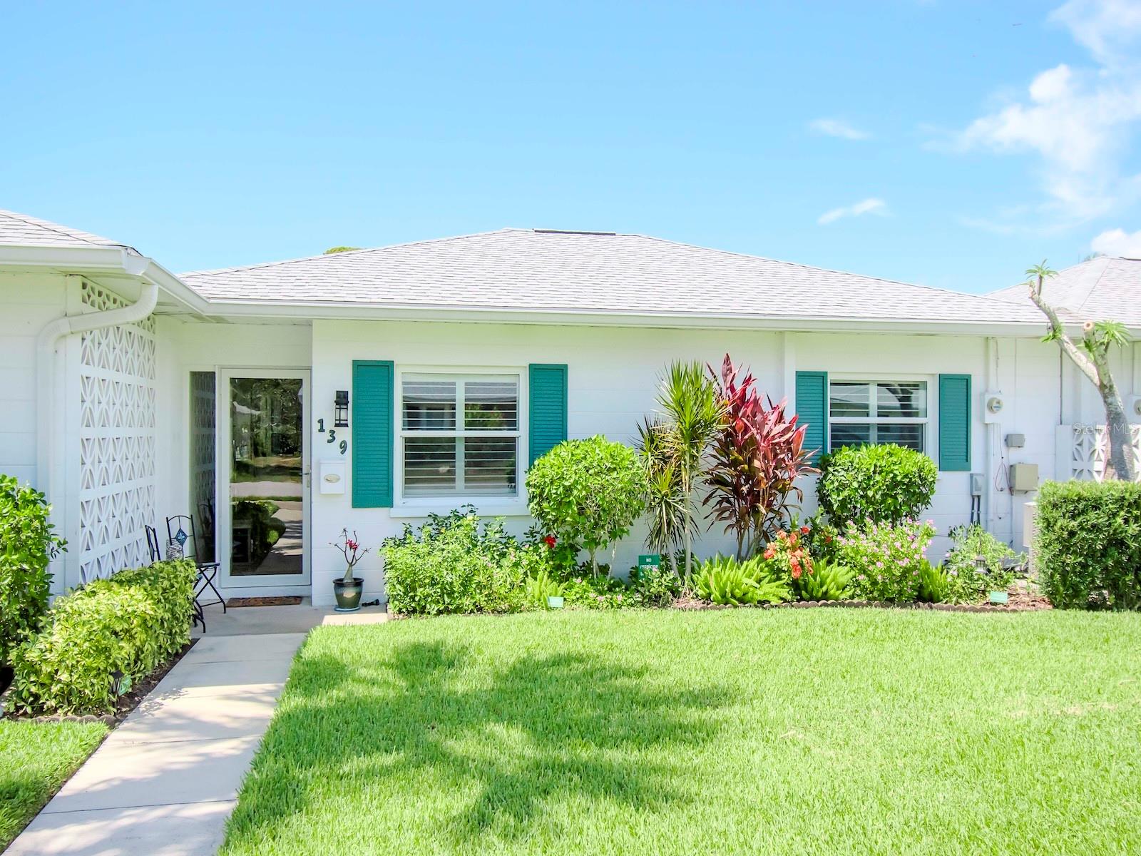 If you are looking for affordable island life living welcome to Beach Manor Villas on the island in Venice, a 55+ community.  This unit is a 2 bedroom/1 bathroom bright and clean villa and is being sold fully furnished.  This villa offers hurricane impact windows with newer plantation shutters (2022), a newer dishwasher, disposal and microwave (all 2023), ceiling fans are also newer as is the fully glass storm door and the updated exterior lighting fixtures.  Also added was a barn door for the hall closet.  There is a washer and dryer for your convenience in the carport and a shed for extra storage.  The electric panel was updated in 2023, attic insulation was added in 2024, and UV protection was added to the A/C unit in 2023.  The front gutters were added in 2020, and the roof was replaced in 2018.  Quintessential beach life living begins here less than 1 mile to the Gulf beaches.  In addition, there is a public golf course with a driving range nearby, Sharkey's fishing pier, and historic downtown Venice with a farmers market every Saturday morning a short bike ride away.  Venice theatre, access to the Legacy bike trail and restaurants and entertainment are all within minutes!  Beach manor villas has an active social committee throughout the year.  There is a year round heated pool, shuffleboard court and a community clubhouse.