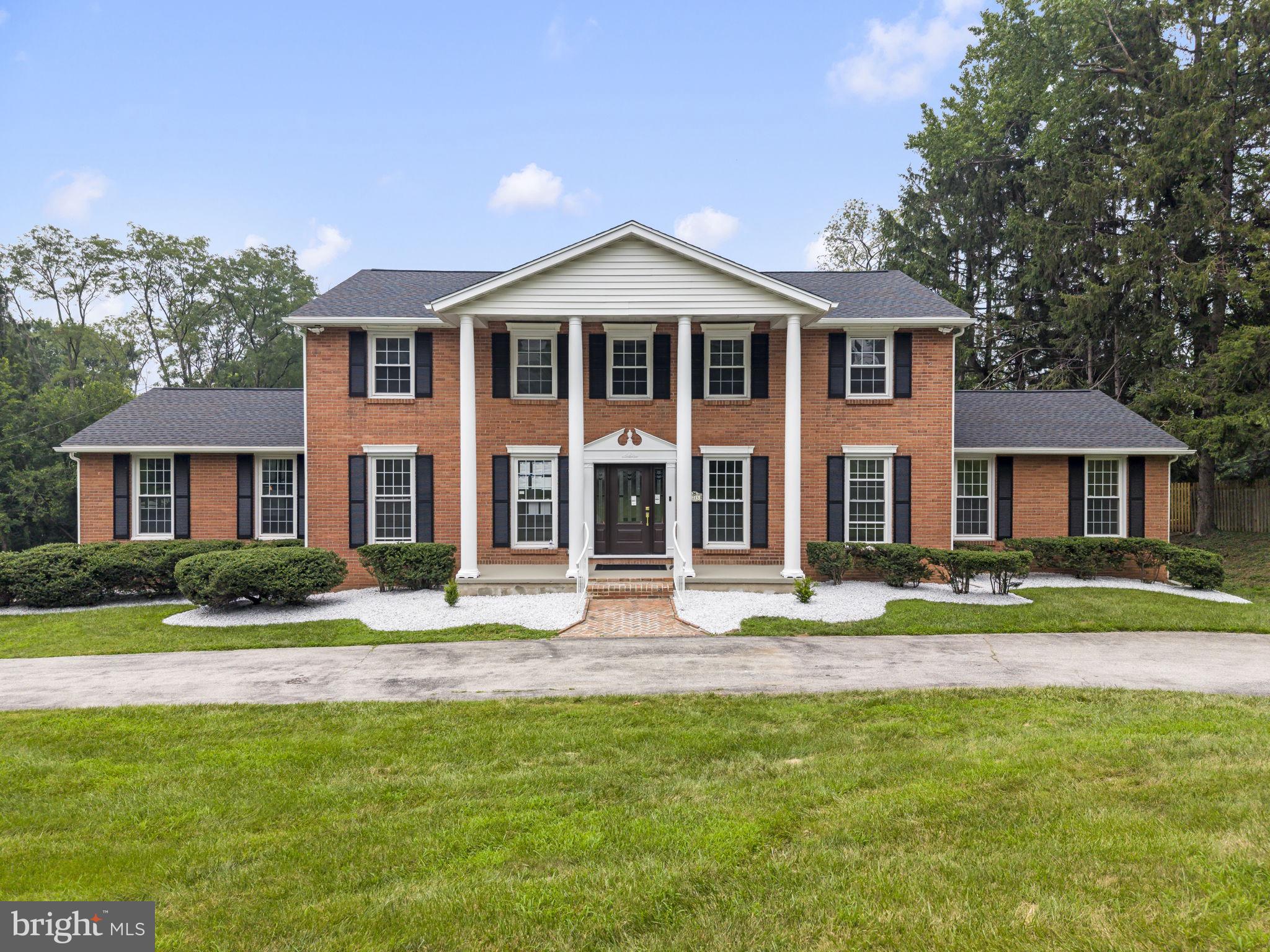 Welcome to 1215 Club House Rd., an exquisitely renovated residence where timeless Gladwyne charm meets modern luxury. Nestled on a beautifully landscaped 0.83-acre lot in one of Gladwyne's most desirable neighborhoods, this exceptional home offers 5 bedrooms, 4 full bathrooms, and 1 half bath in the award-winning Lower Merion School District. A NEW circular driveway leads to the dignified front entrance, highlighted by elegant two-story columns that create a grand first impression. Inside, a bright, open floor plan seamlessly connects the main living spaces, providing the perfect setting for both everyday living and effortless entertaining. Every detail of this home has been meticulously updated, featuring exceptional craftsmanship and today's most desirable finishes. Major improvements include a new roof, new hardwood flooring, a redesigned staircase, beautifully renovated bathrooms, a fully updated kitchen with custom cabinetry, new interior doors, updated plumbing , new modern lighting fixtures throughout and much more. At the heart of the home is a stunning gourmet kitchen featuring premium-quality Fabuwood cabinetry, elegant quartz countertops, custom built-ins, high-end Café stainless steel appliances, a spacious breakfast area, and a convenient butler's pantry. The kitchen flows effortlessly into the sun-filled family room, where skylights and sliding glass doors overlook the tranquil backyard and provide access to the deck and the covered rear porch with a fireplace. The spacious formal living room is filled with natural light and anchored by a striking double-sided gas fireplace, creating a warm and inviting atmosphere. The fireplace extends to the covered rear porch, allowing you to enjoy cozy evenings and seamless indoor-outdoor living year-round. The main-level primary suite offers the convenience of first-floor living and features a spacious walk-in closet with a laundry area and a luxurious ensuite bath. Upstairs, a second primary suite includes another oversized walk-in closet and a private ensuite bath, while two additional generously sized bedrooms share a beautifully appointed full bathroom. The finished walkout lower level provides exceptional additional living space, featuring a spacious recreation room with a gas fireplace and direct access to the ground-level backyard patio. This level also includes a private guest suite complete with a walk-in closet, ensuite bath, and its own laundry area, making it ideal for overnight guests, extended family, or an au pair. An additional finished space offers endless flexibility for a home gym, media room, playroom, or home office. Additional highlights include an oversized two-car garage, a whole-house generator for added peace of mind, professionally landscaped grounds, recessed lighting, rich hardwood flooring, and designer ceramic tile bathrooms. Perfectly situated in a quiet, safe, and close-knit community surrounded by parks, nature preserves, and miles of scenic hiking trails, this home is just minutes from Center City Philadelphia via I-76, I-476, and multiple regional rail lines. Philadelphia Country Club is only minutes away, while the charming shops, restaurants, and cafés of Gladwyne, Bryn Mawr, and Conshohocken are all within easy reach. Offering the very best of Main Line living, this exceptional home is truly move-in ready. Simply unpack and begin enjoying the Gladwyne lifestyle at its finest. For added confidence, the home also includes a two-year Select Home Warranty, providing valuable protection and peace of mind for the new owner.