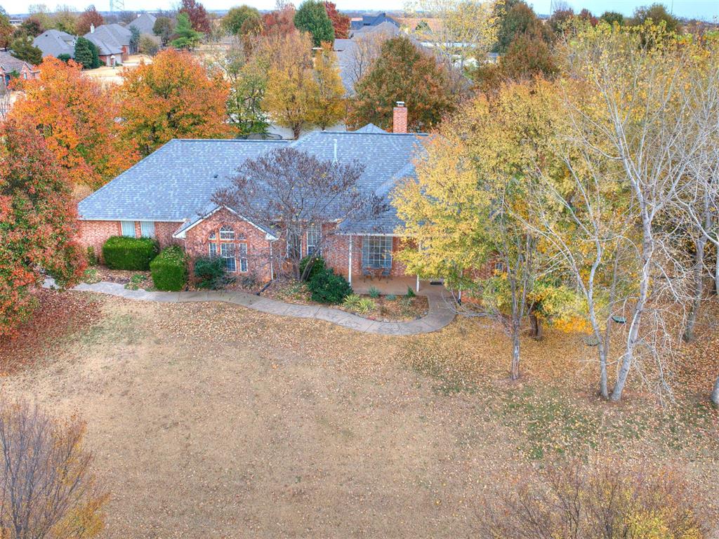 Welcome to this charming one-level home offering 3 beds, 2 baths, and a dedicated office featuring beautiful bamboo floors.  Situated on a spacious 1/2-acre corner lot in Logan County with highly desired Edmond Schools, this property combines space, comfort, and convenience.  Inside, you'll love the gorgeous woodwork, abundant windows, and natural light throughout.  The open-concept living room flows seamlessly into the kitchen, creating ideal space for everyday living and entertaining.  The kitchen includes a gas stove, extra-quiet Bosch dishwasher, and plenty of storage.  The private primary suite features a raised ceiling, double sinks, jetted tub, large shower, and an expansive Australian closet.  Additional highlights include a 3-car side-load garage, inground storm shelter, outdoor hot tub, gas fireplace (convertible to wood burning), and a laundry room equipped with a sink, plus both gas and electric hookups.  Recent updates add peace of mind:  New roof (Jan 2020), New HVAC system (June 2022), New hot water heater (Jan 2025), New carpet in living and dining (Oct 2022), fresh paint in living, dining, hall and entry (Sept 2022). Property has convenience of public water with a private well for irrigation. This home offers space, functionality and timeless charm - don't miss the opportunity to make it yours!